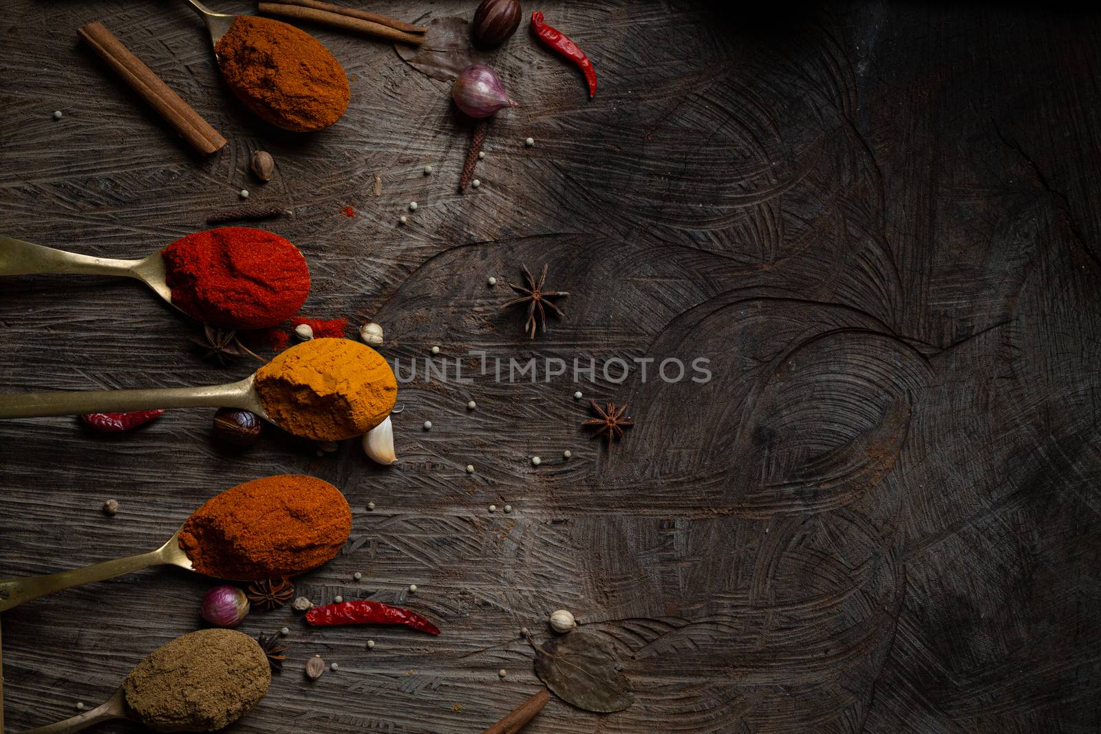 Condiment of indian food Spice garnish background on wood table top view. Seasoning of Asian organic herb cuisine flavour in kitchen board, chilli spicy taste concept