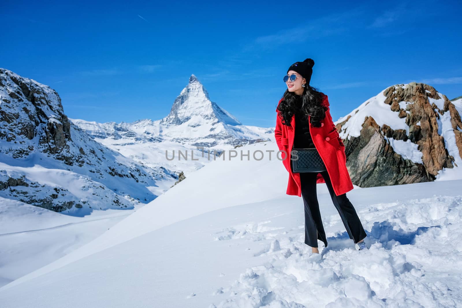 Young Woman Tourists see beautiful view of snow mountain Matterh by Surasak