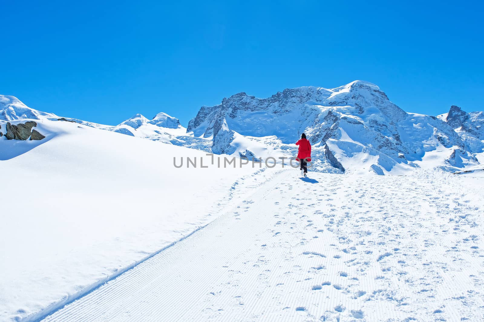 Young Woman Tourists see beautiful view of snow mountain Matterhorn peak, Zermatt, Switzerland.