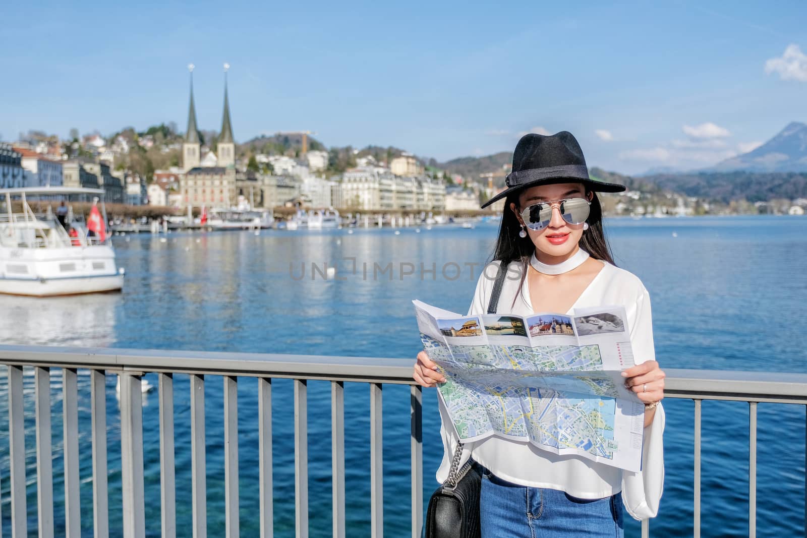 Young female tourist looking map at center city of Lucerne ,Swit by Surasak