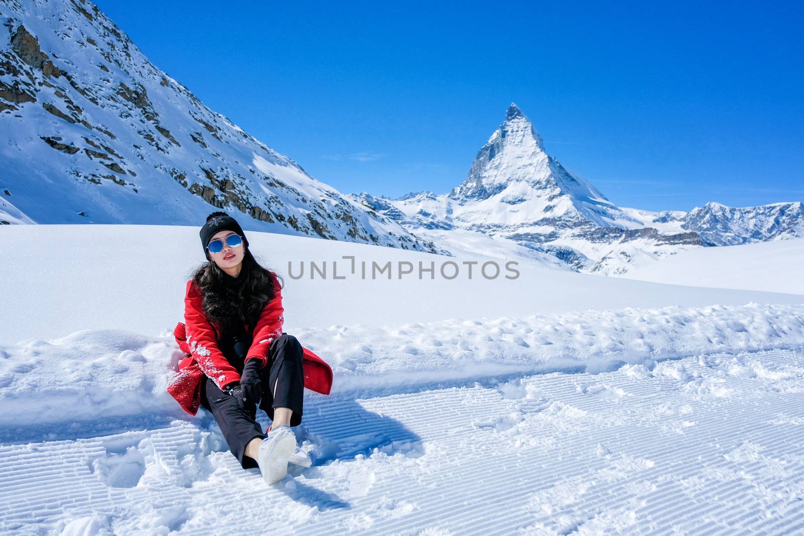 Young Woman Tourists playing snow in mountain Matterhorn peak, Z by Surasak