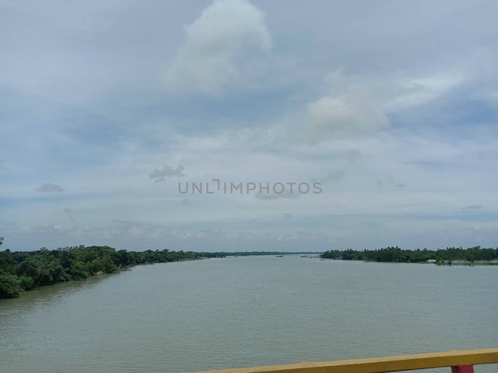 concrete bridge on river with sky