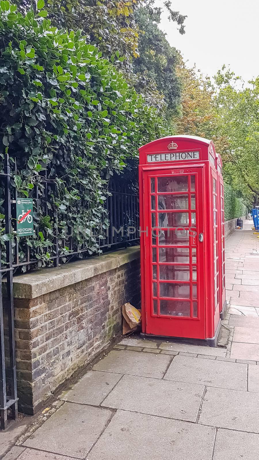 Classic red British telephone booth in London by DamantisZ