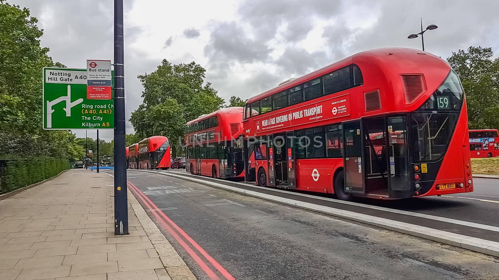 London, UK - July 8, 2020: Modern red double-decker buses waiting for people in central London by DamantisZ