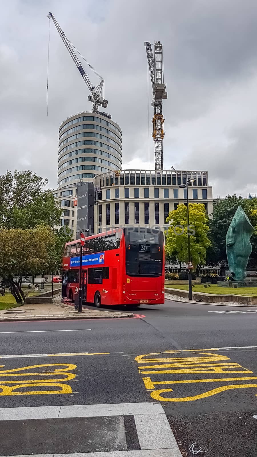 London, UK - July 8, 2020: Modern red double-decker bus waiting for people in central London by DamantisZ