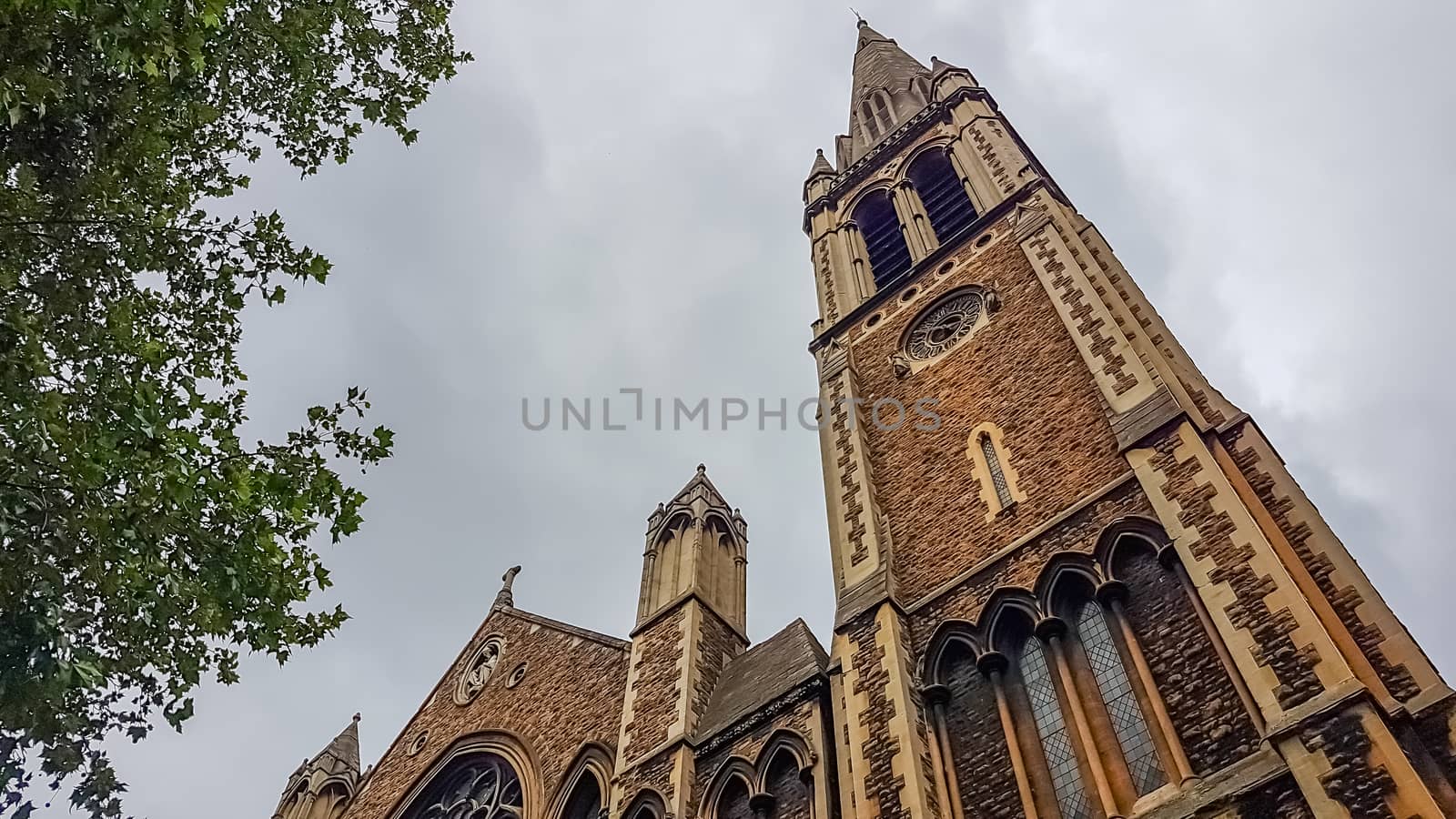 London, UK - July 8, 2020: Low angle shot of St. Matthew's church. Cloudy sky as a background.