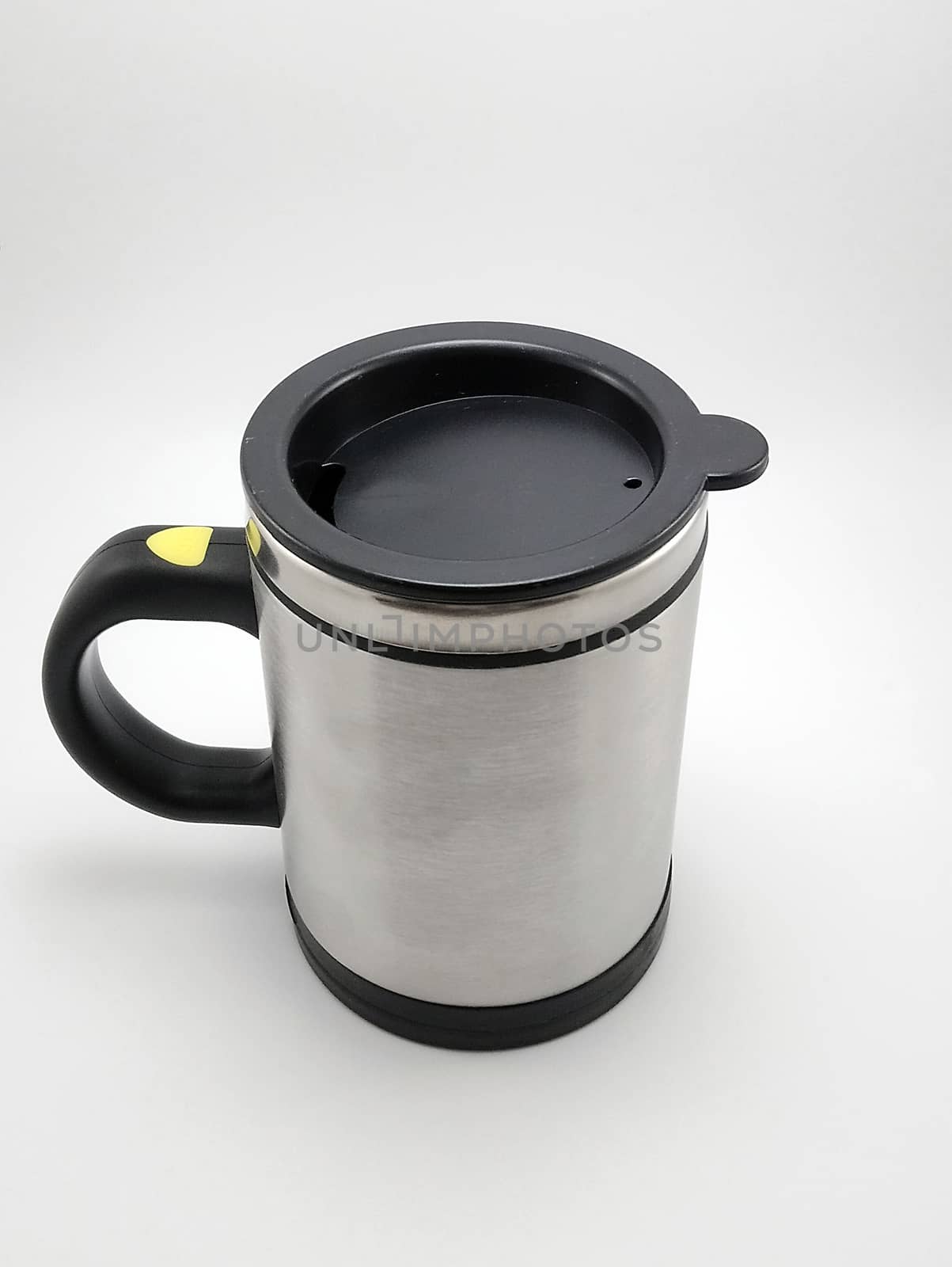 Self stirring mug made from aluminum metal with lid cover use to stir liquid content before drinking