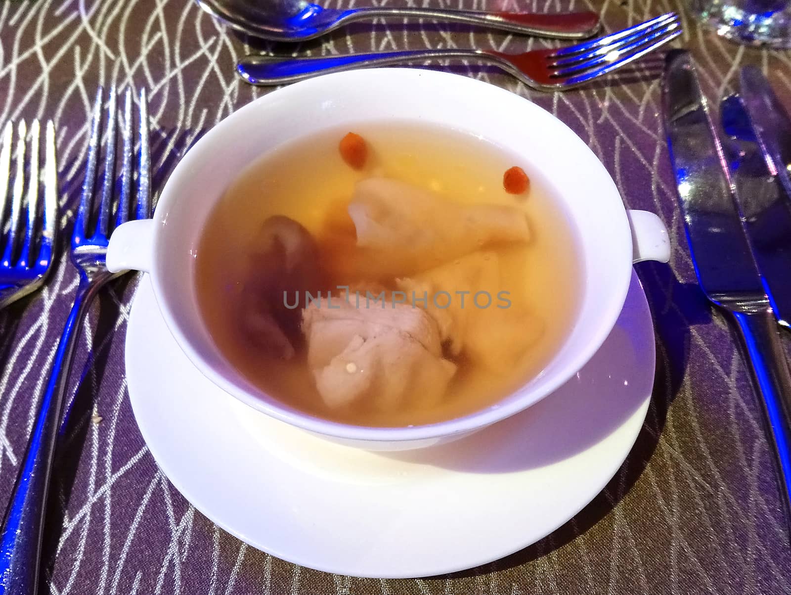 Chicken soup on white bowl serve in hotel restaurant
