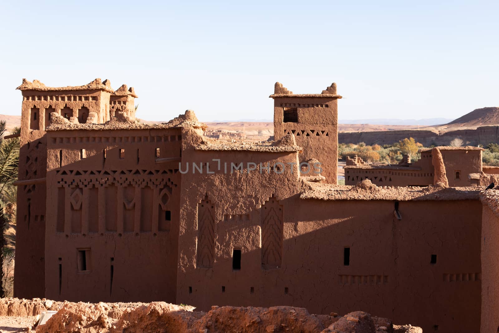 Ait Ben Haddou ksar Morocco, ancient fortress that is a Unesco Heritage site. Beautiful late afternoon light with honey, gold coloured mud brick construction the kasbah, or fortified town dates from 11th cent. and is on the former caravan route from the Sahara and Marrakech. The location has been used for many famous movies. High quality photo