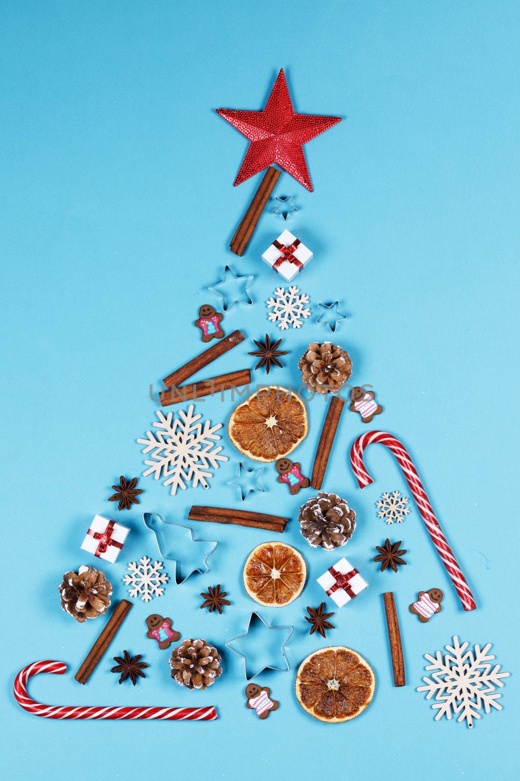 Christmas flat lay styled scene fir tree of decorations on blue background