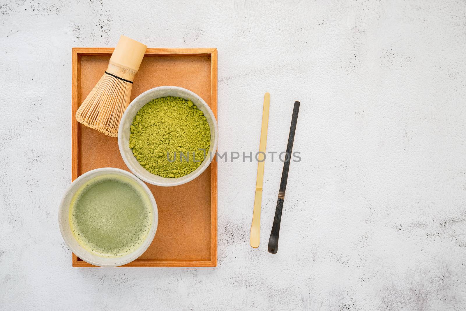 Matcha green tea powder with bamboo matcha whisk brush  setup on by kerdkanno