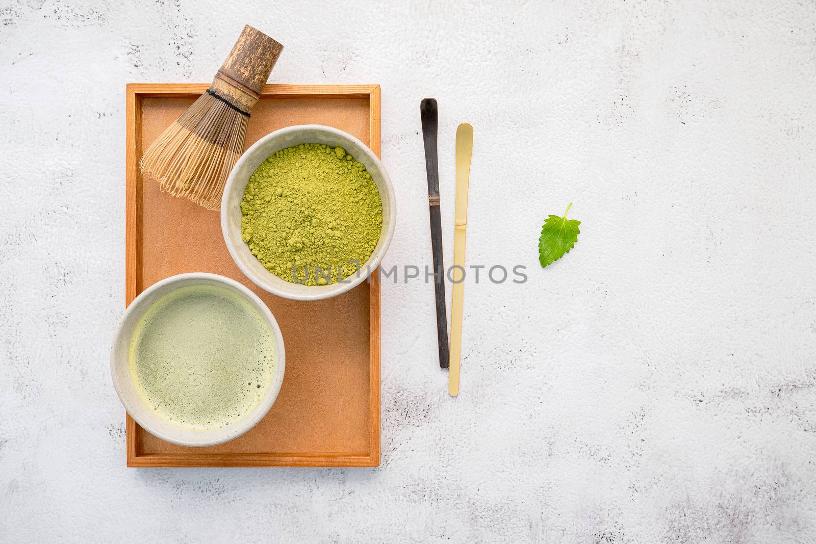 Matcha green tea powder with bamboo matcha whisk brush  setup on by kerdkanno