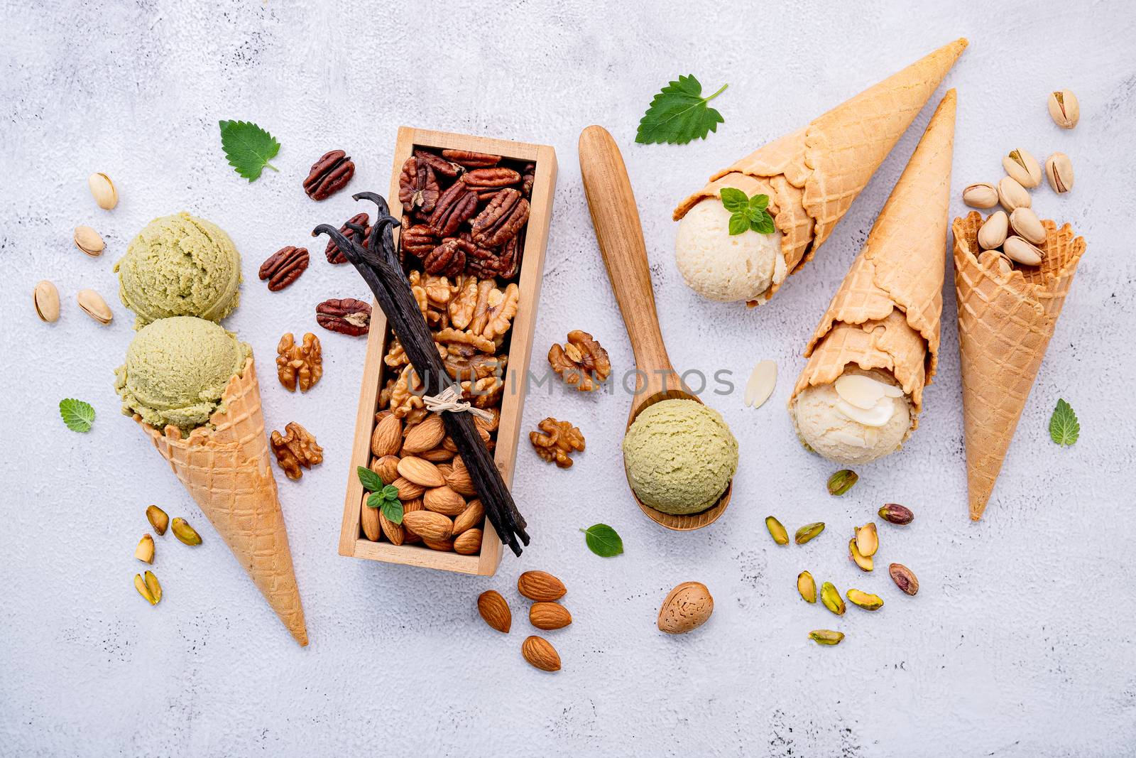 Pistachio and vanila ice cream in cones  with mixed nut setup on by kerdkanno