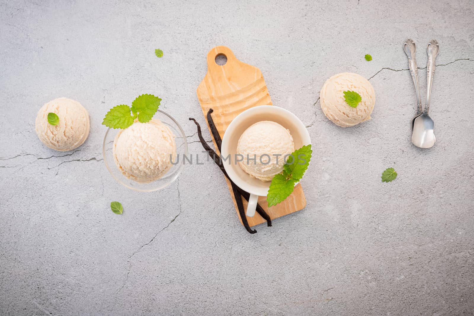 Vanilla ice cream flavor in bowl with vanilla pods setup on concrete background . Summer and Sweet menu concept.