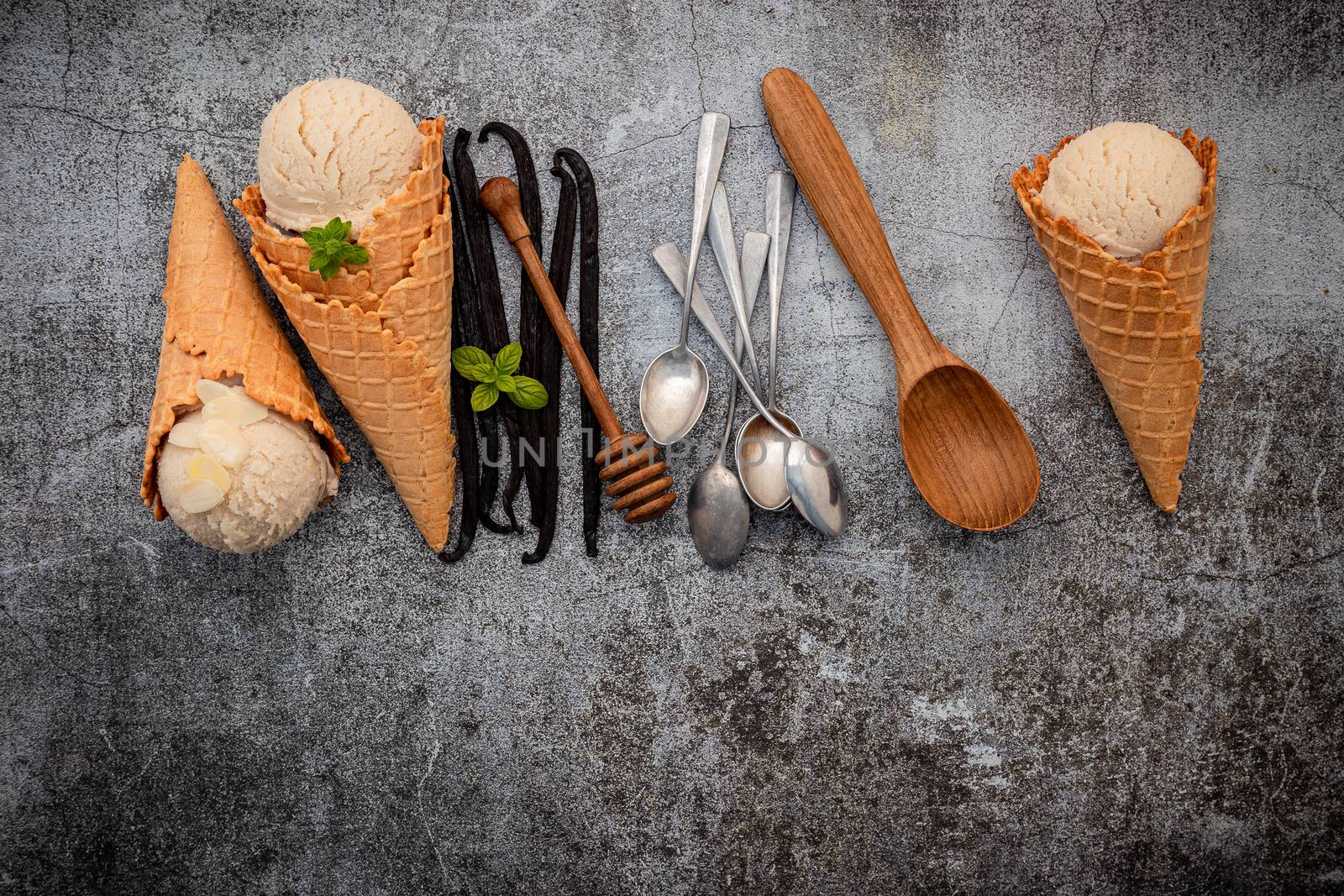 Vanilla ice cream flavor in cones with Vanilla pods setup on concrete background . Summer and Sweet menu concept.