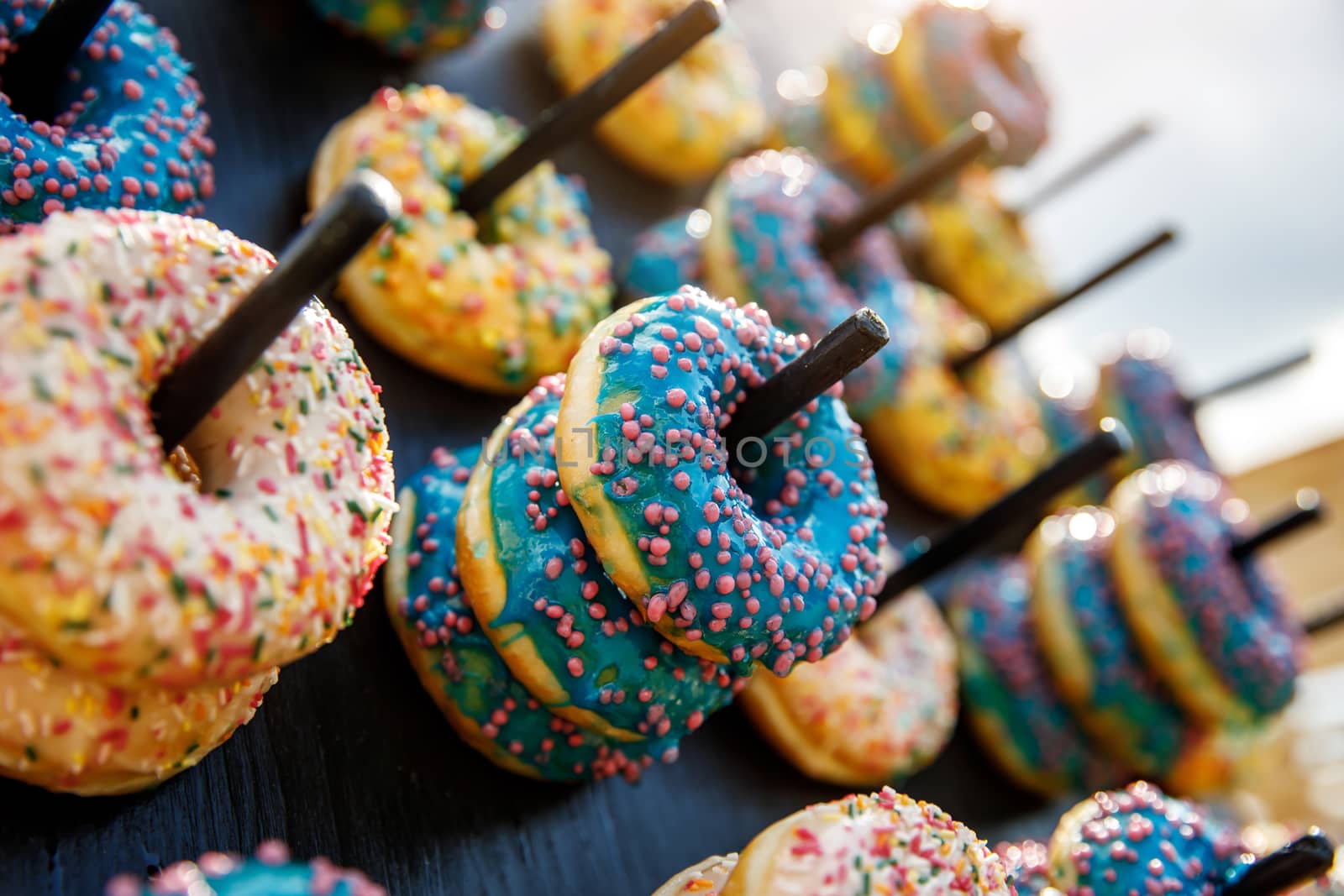 Assorted donuts on a wand. Dessert colorful snack.