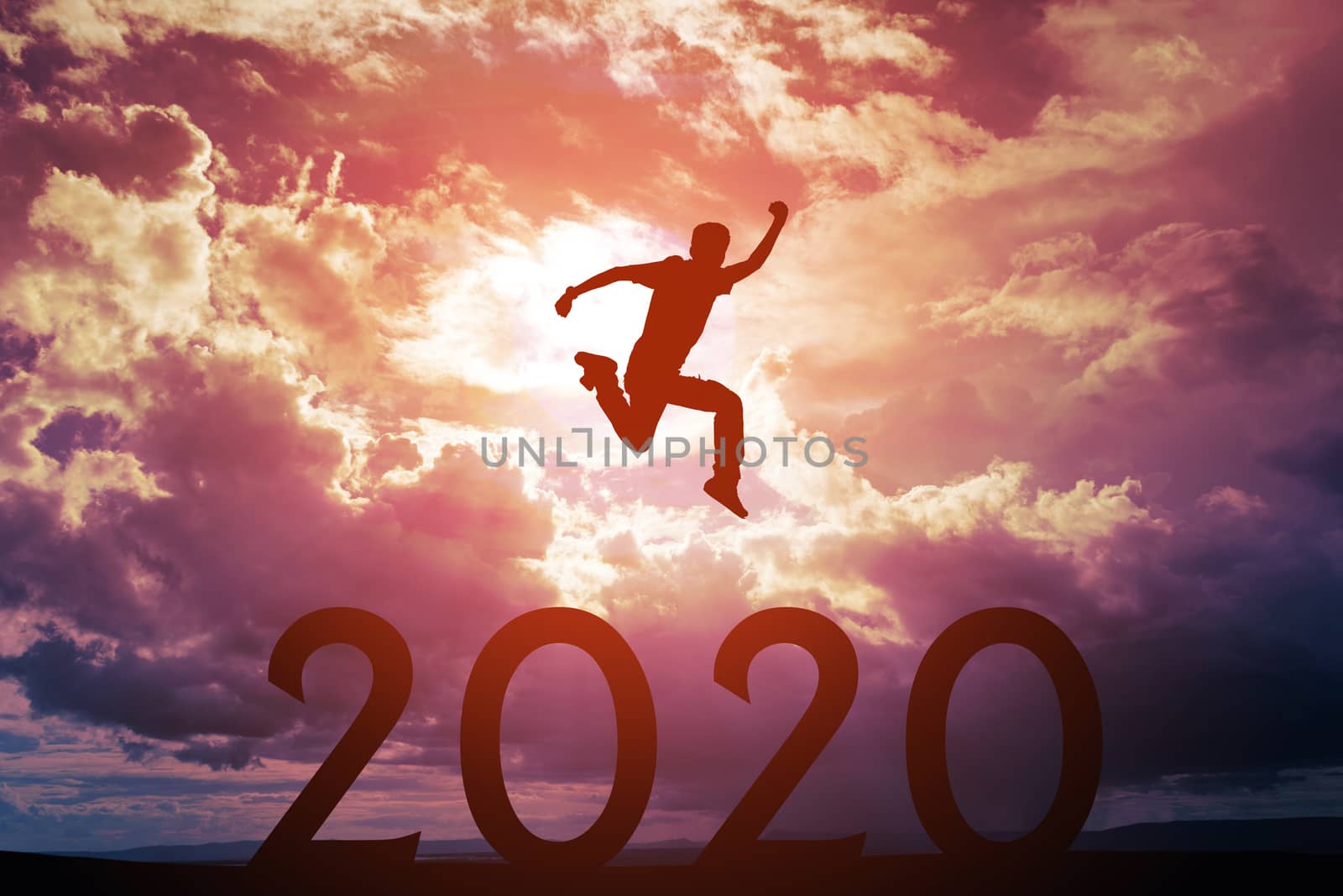 Silhouette of young man jumping over the numbers 2020 years with beautiful sunset, concepts of news year and business target.