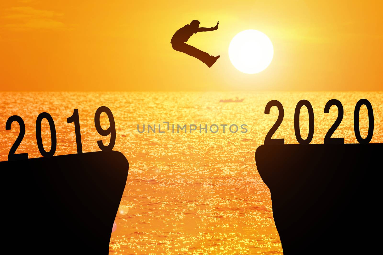 Silhouette of young business mans jumping from the cliff that has the year number 2019 to the side that has the year number 2020 with sun rise at the sea background, Concept for new year target.