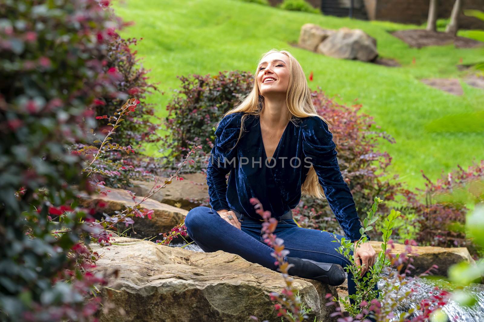 A gorgeous blonde model poses outdoors in her fall clothes