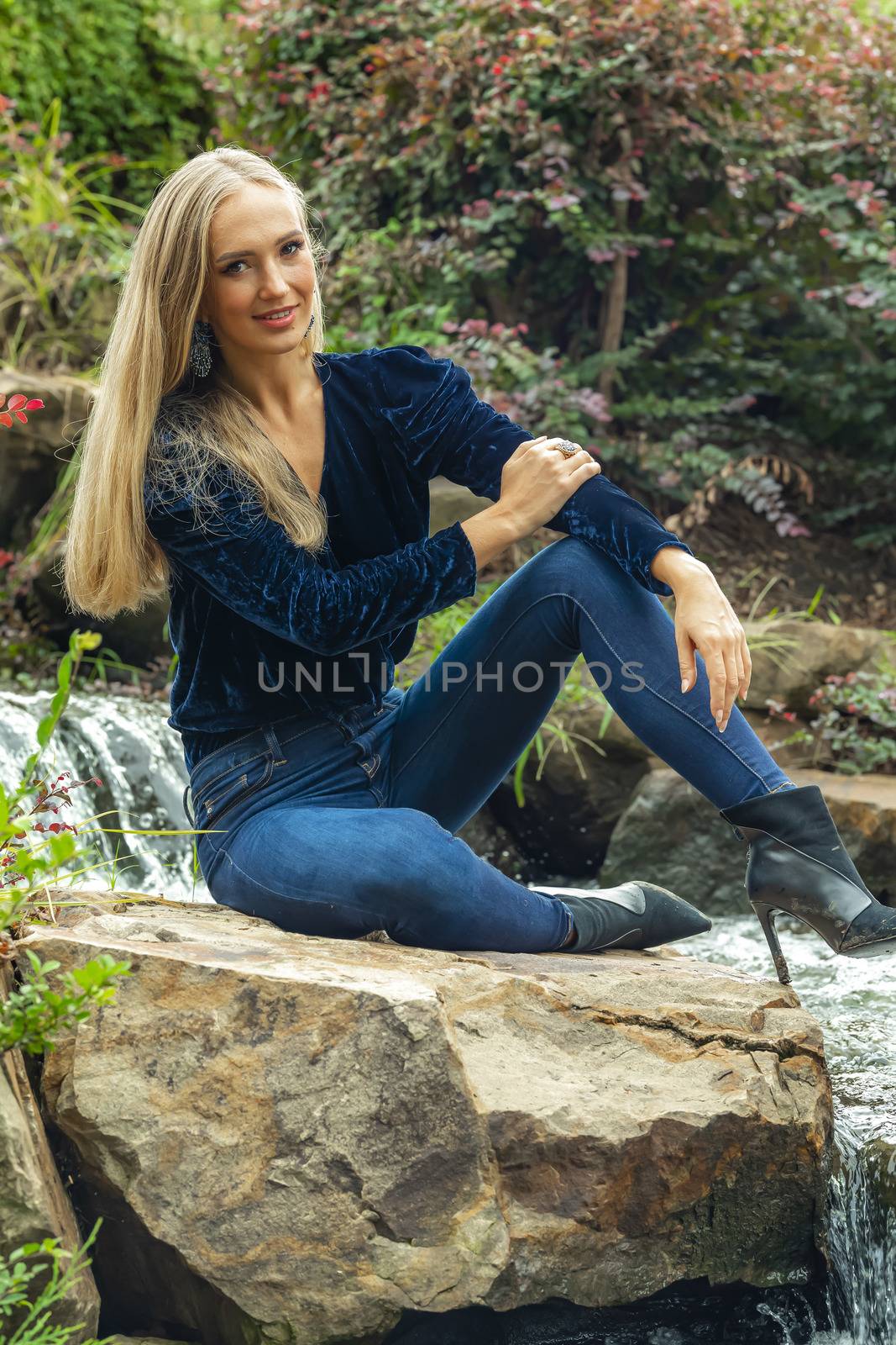 A gorgeous blonde model poses outdoors in her fall clothes