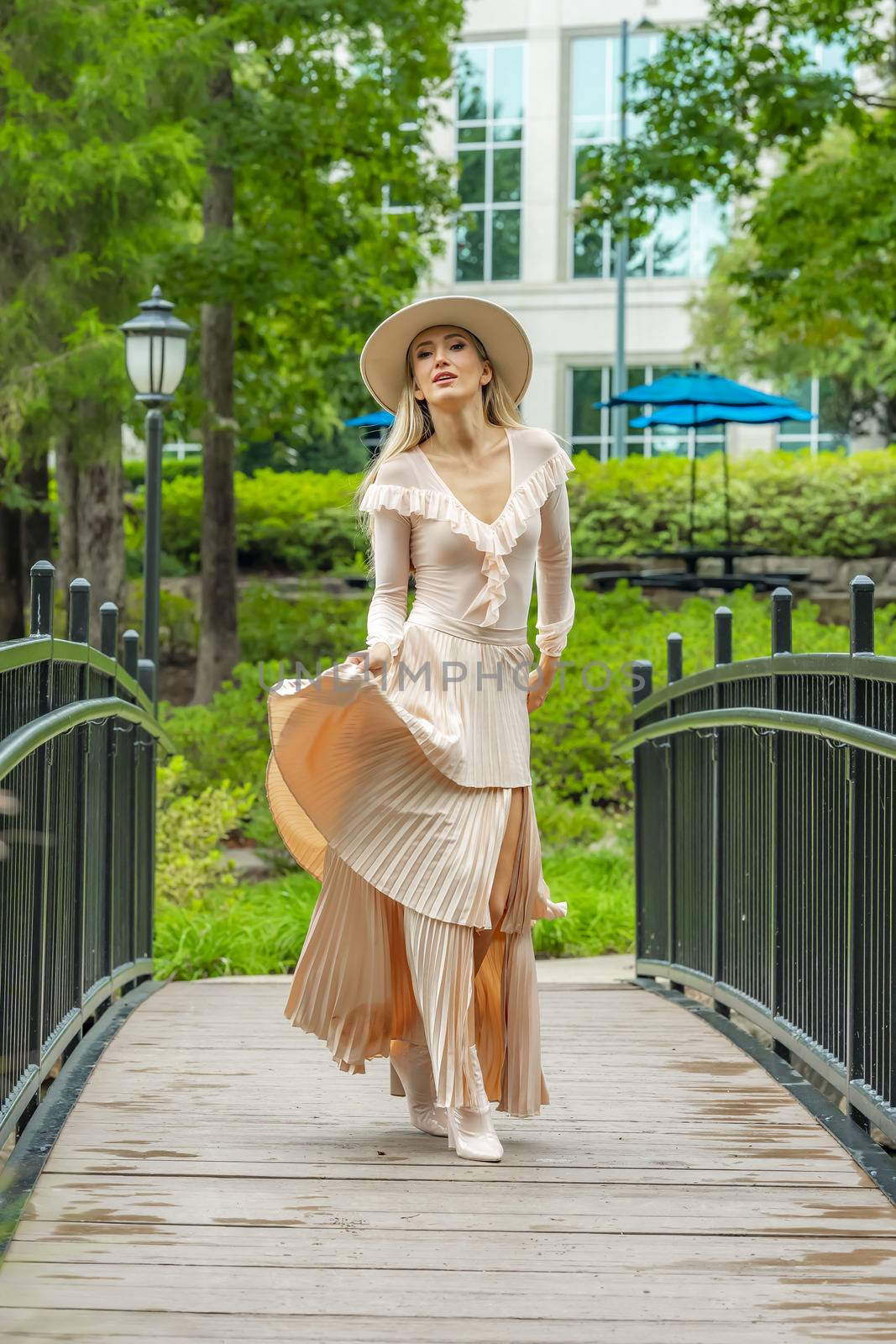 A gorgeous blonde model poses outdoors in her fall clothes