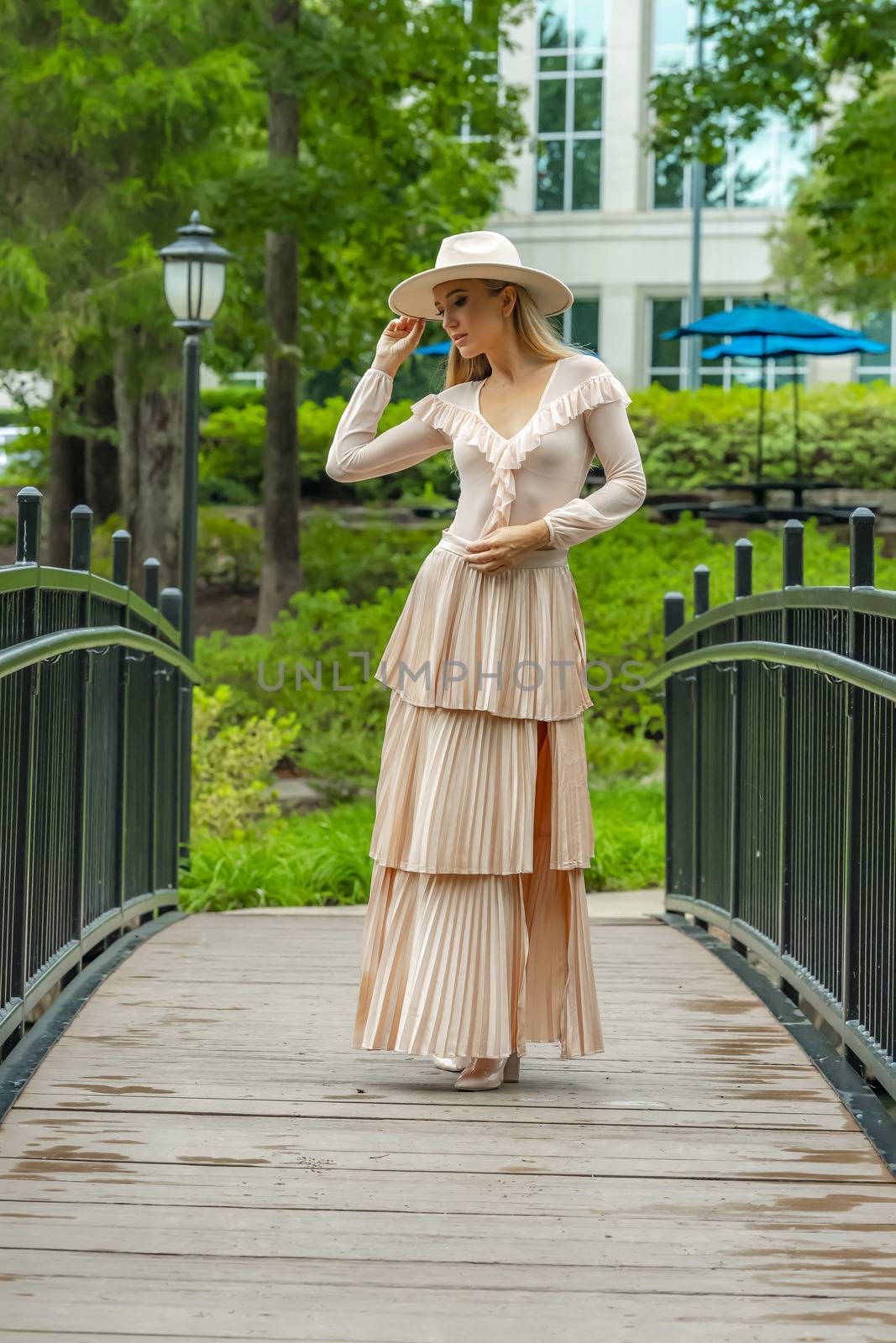 A gorgeous blonde model poses outdoors in her fall clothes