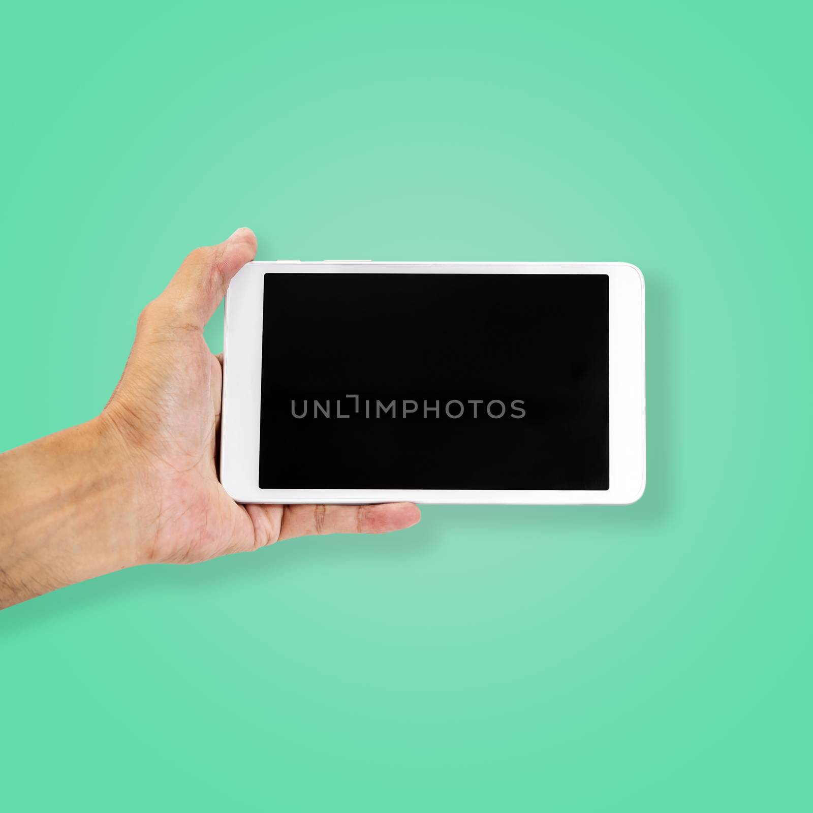 Hand holding smart-phone isolated on beautiful pastel color background, with clipping path.