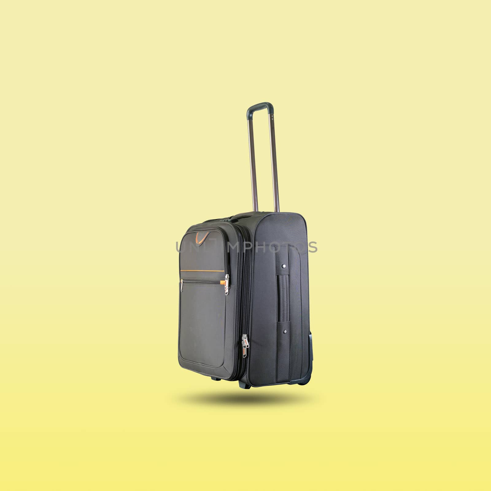 Black suitcase isolated on beautiful pastel color background by wattanaphob