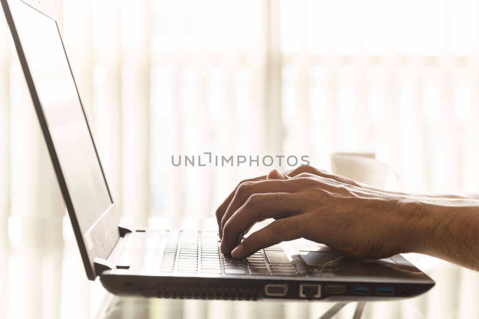 Close-up hands of businessmen are using laptops in the office.