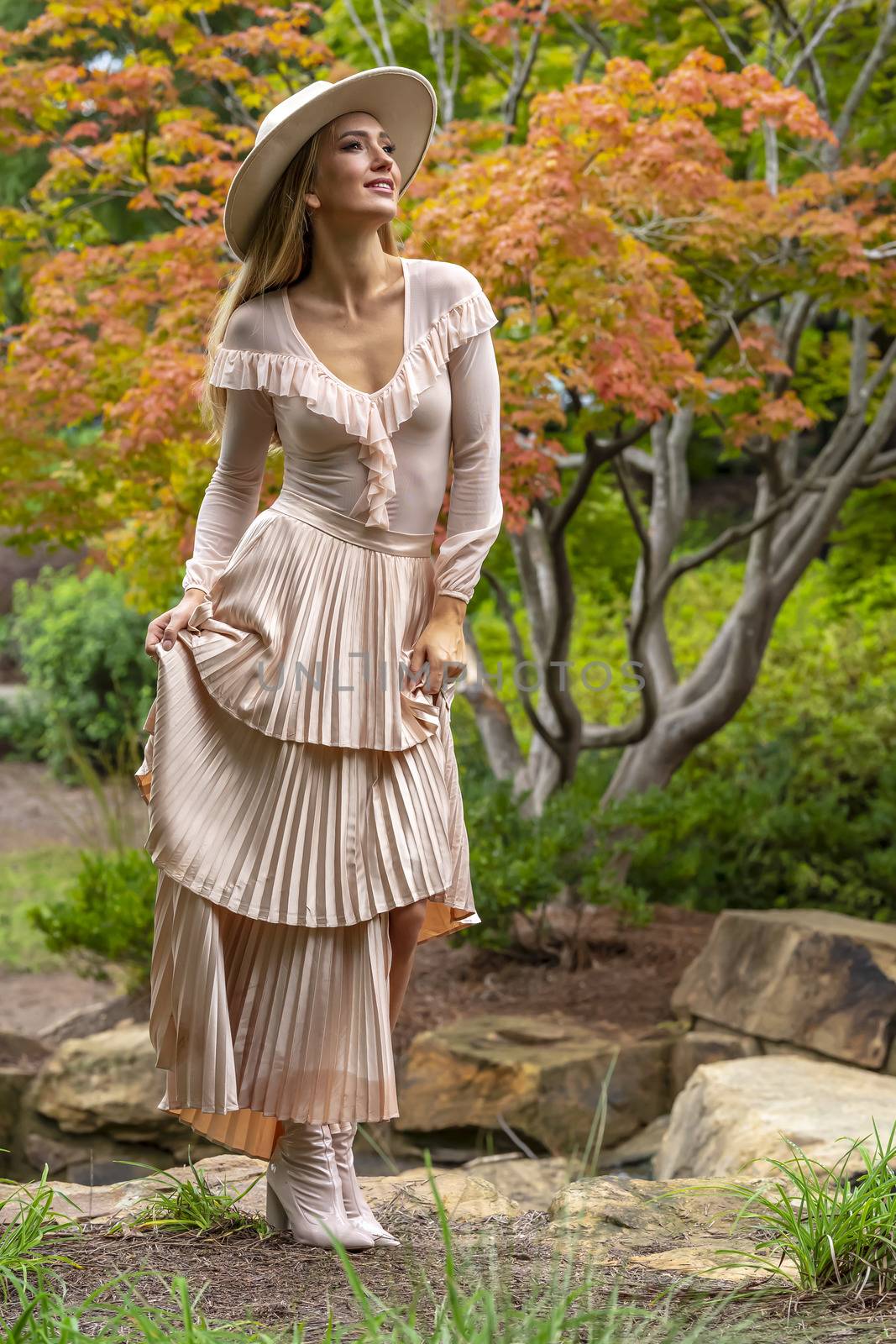 A gorgeous blonde model poses outdoors in her fall clothes