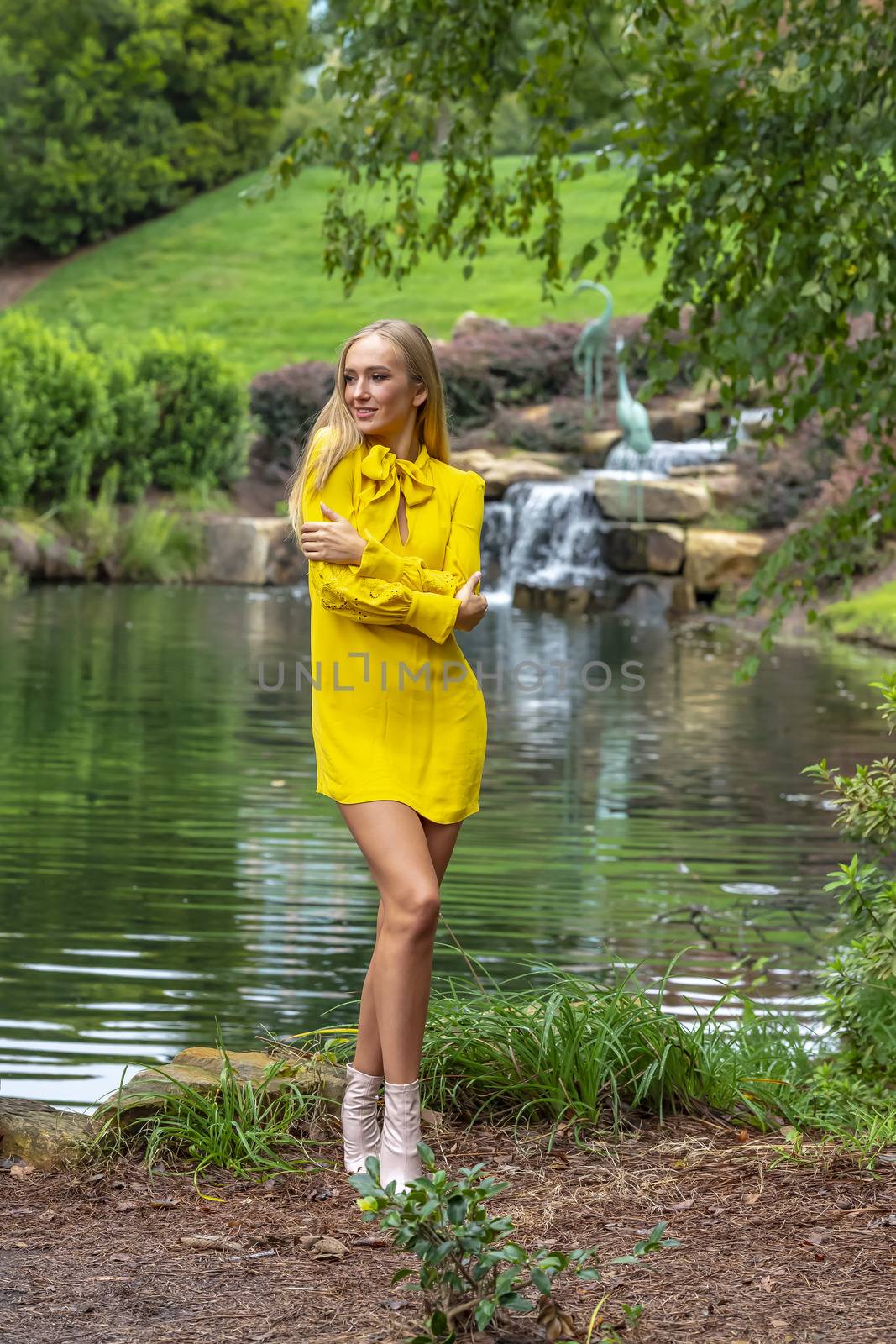 A gorgeous blonde model poses outdoors in her fall clothes