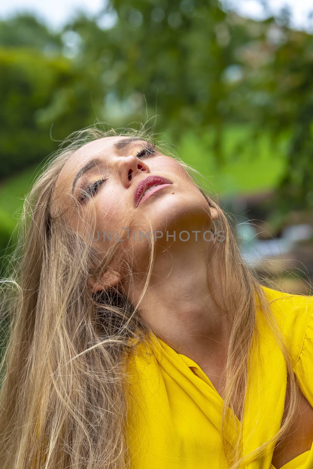 A gorgeous blonde model poses outdoors in her fall clothes