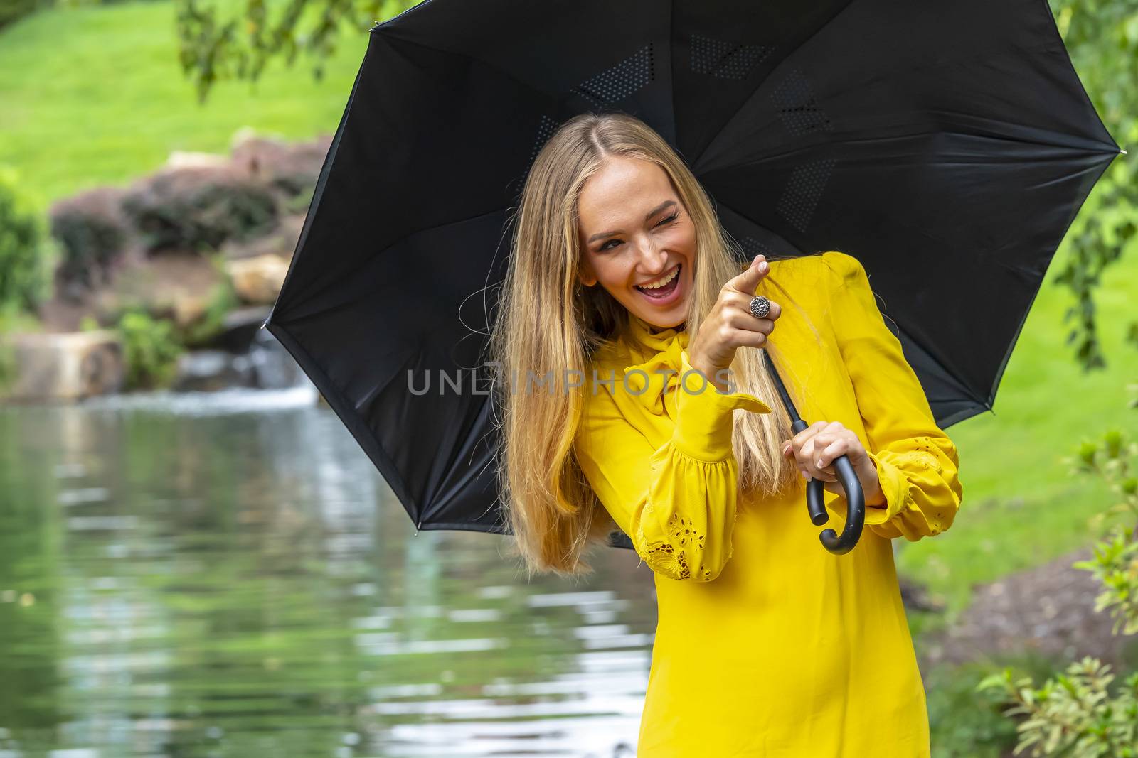 A gorgeous blonde model poses outdoors in her fall clothes