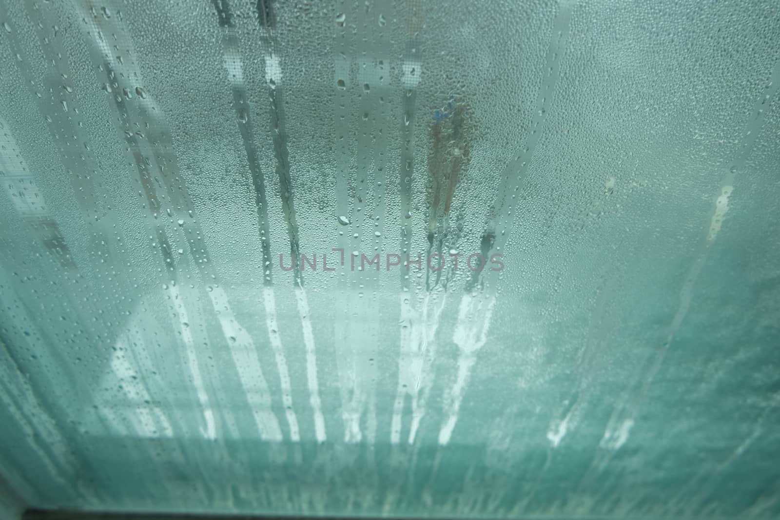 Bright grey color glassy texture, with water drops on it. Water drop glassy background