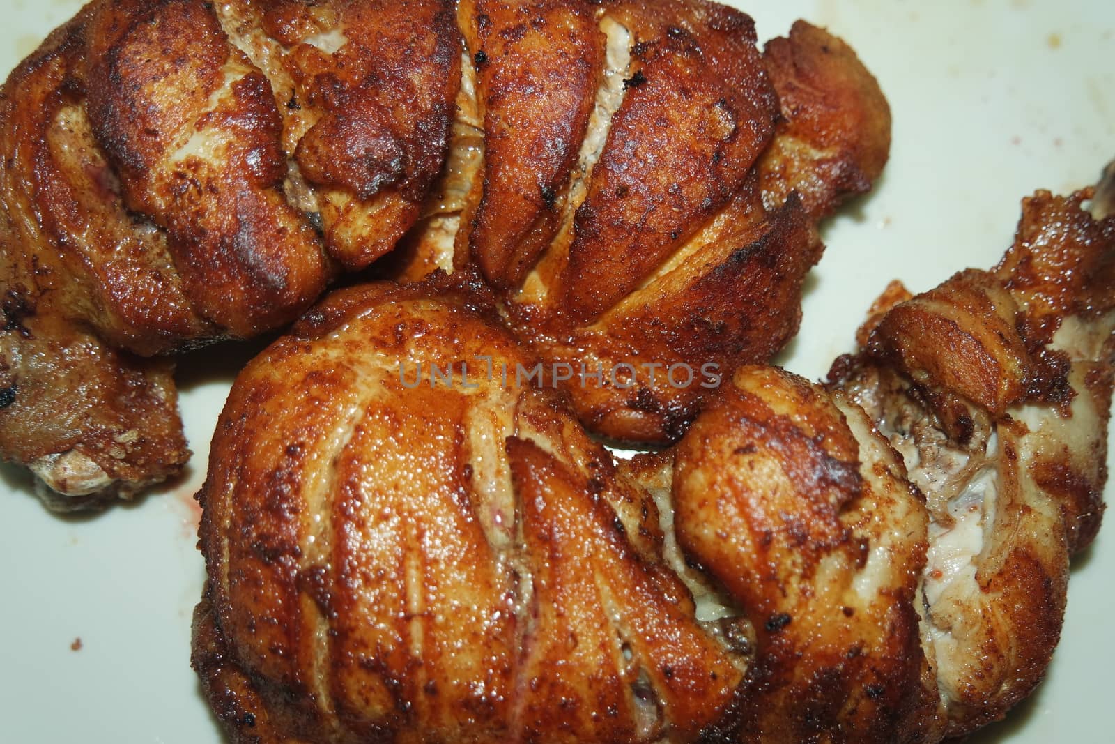 Fried, grilled baked chicken pieces with marinated spices on it. Tasty delicious fried chicken barbecue