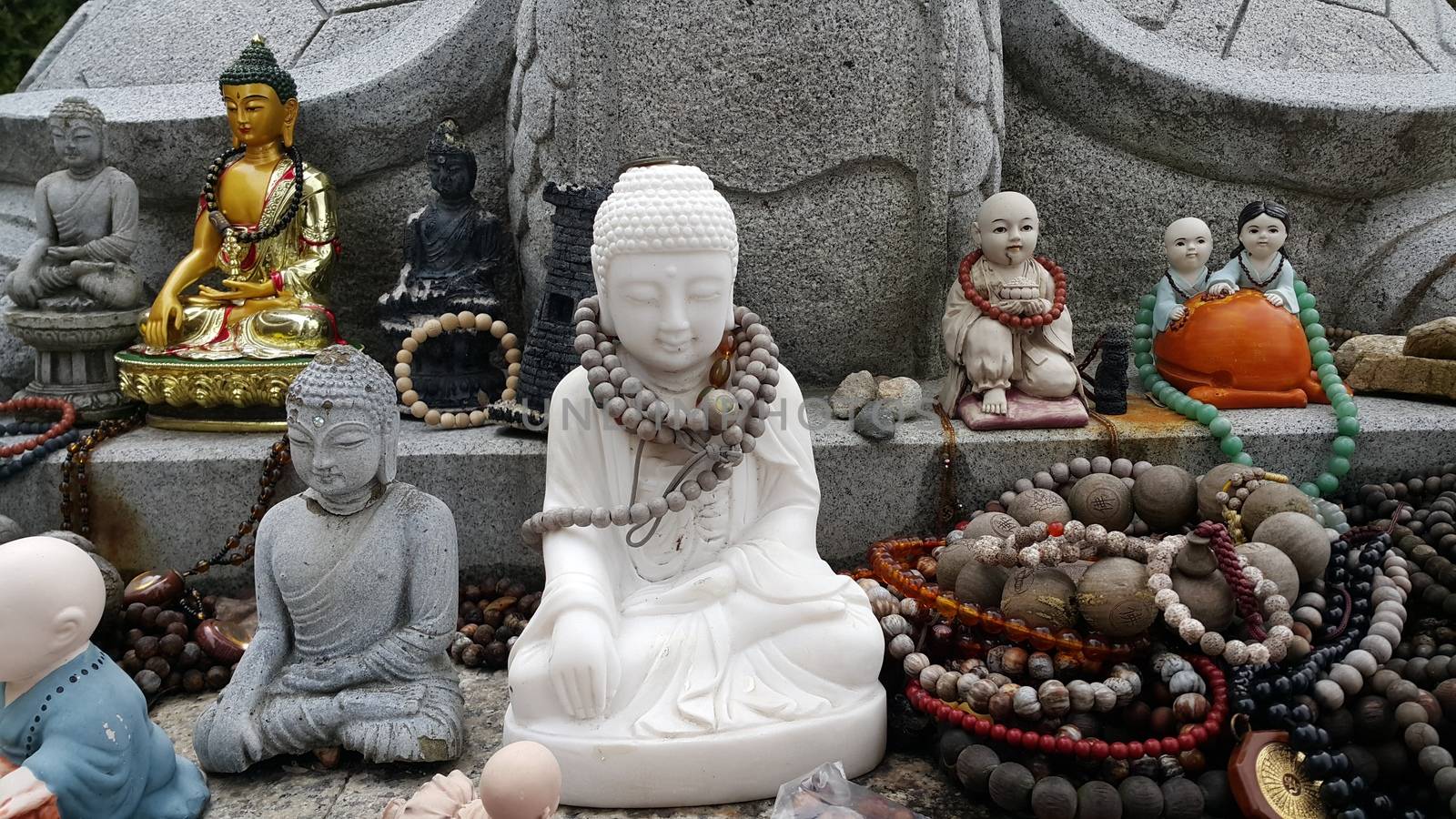 Closeup view of statues of religious monks. Buddha mini statue with beautiful background