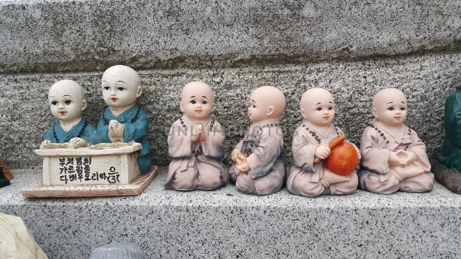 Closeup view of statues of religious monks. Buddha mini statue with beautiful background