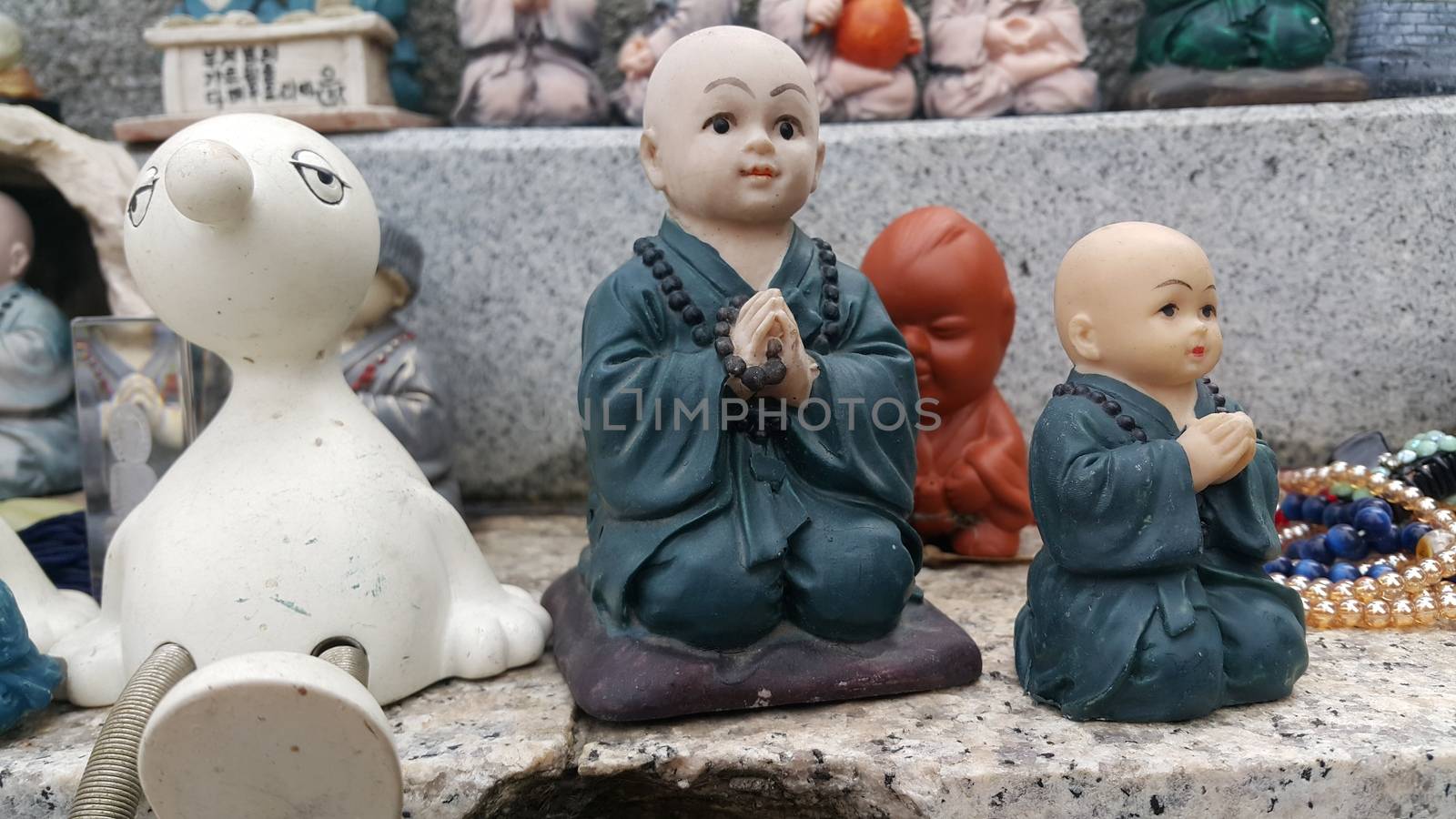 Closeup view of statues of religious monks. Buddha mini statue with beautiful background