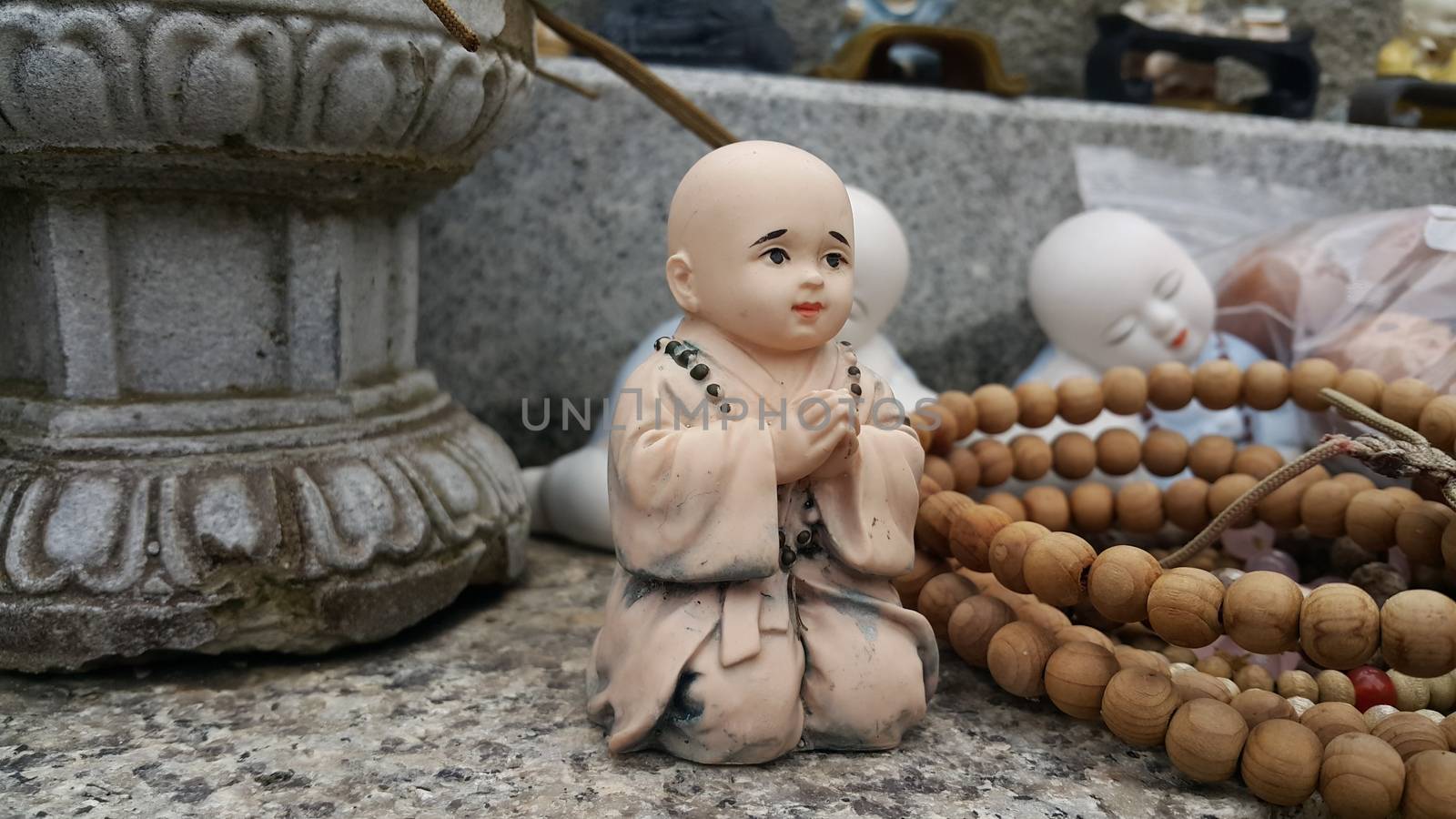 Closeup view of statues of religious monks. Buddha mini statue with beautiful background