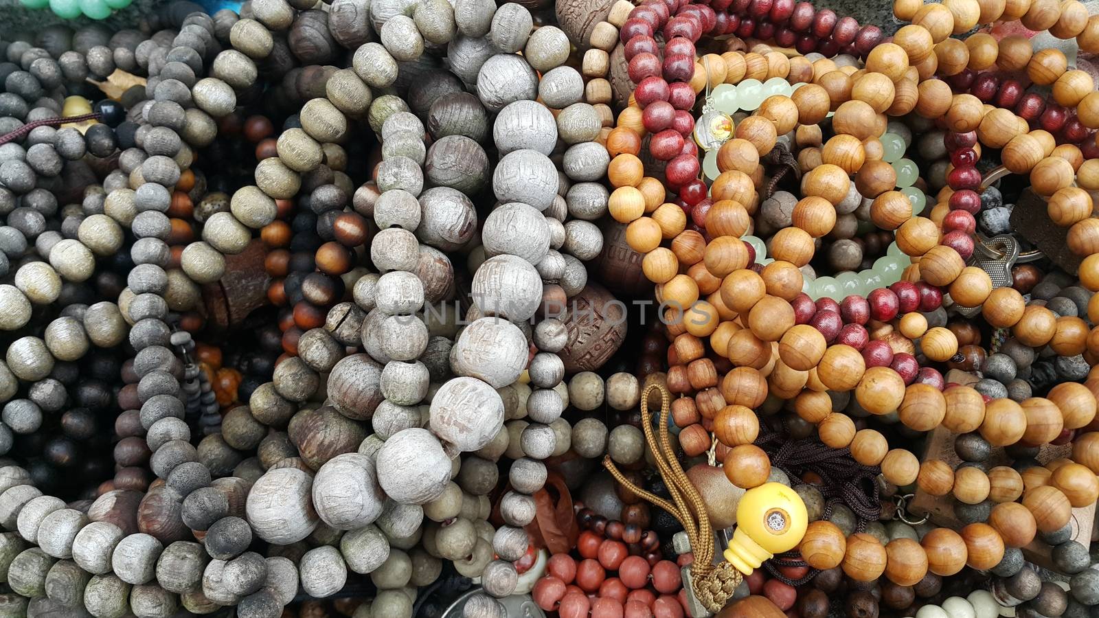 Beautiful wooden prayer beads or rosary placed over fabric background. Religion concept of ramadan or Eid for muslims.