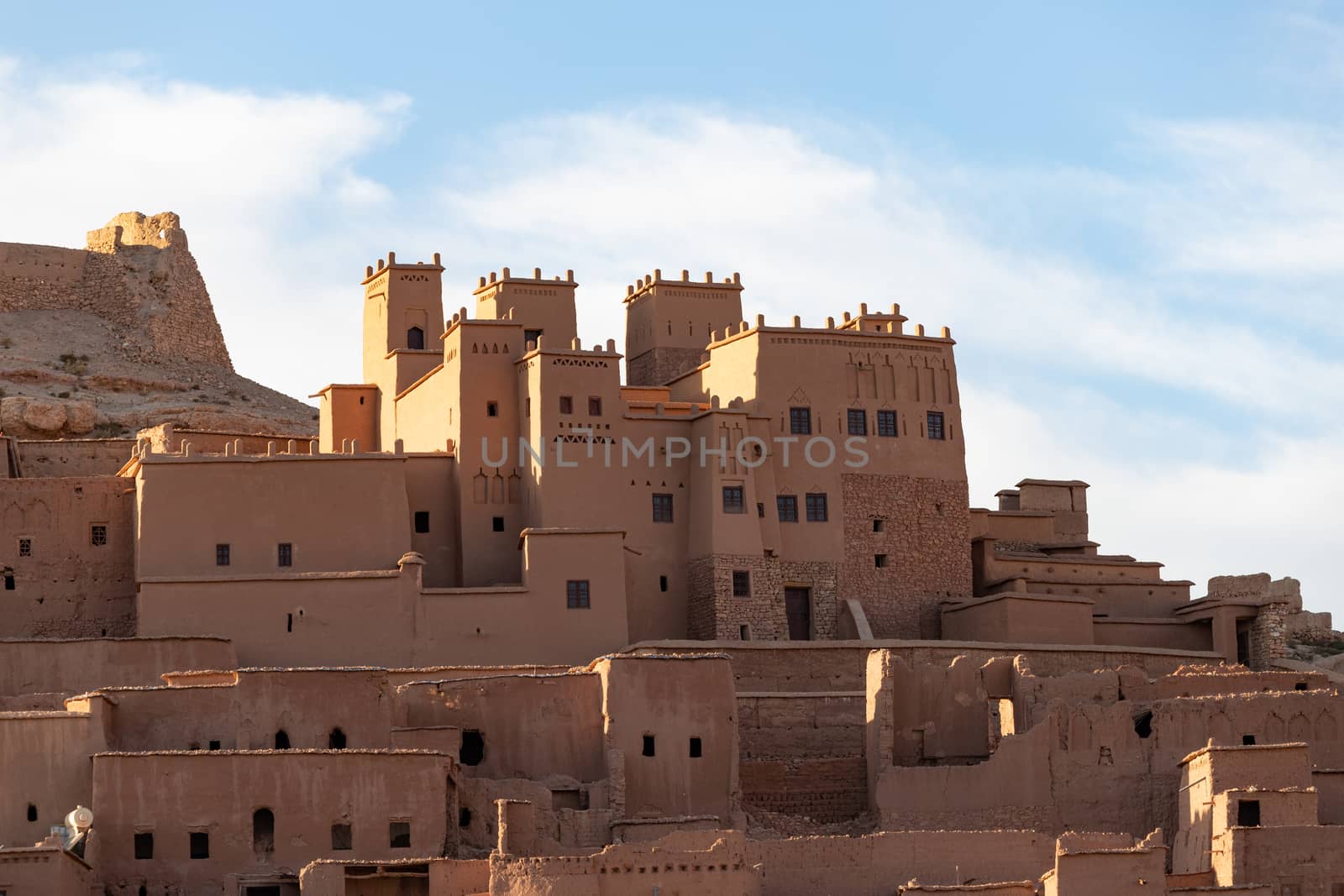 Ait Ben Haddou ksar Morocco, ancient fortress that is a Unesco Heritage site. Beautiful late afternoon light with honey, gold coloured mud brick construction the kasbah, or fortified town dates from 11th cent. and is on the former caravan route from the Sahara and Marrakech. The location has been used for many famous movies. High quality photo