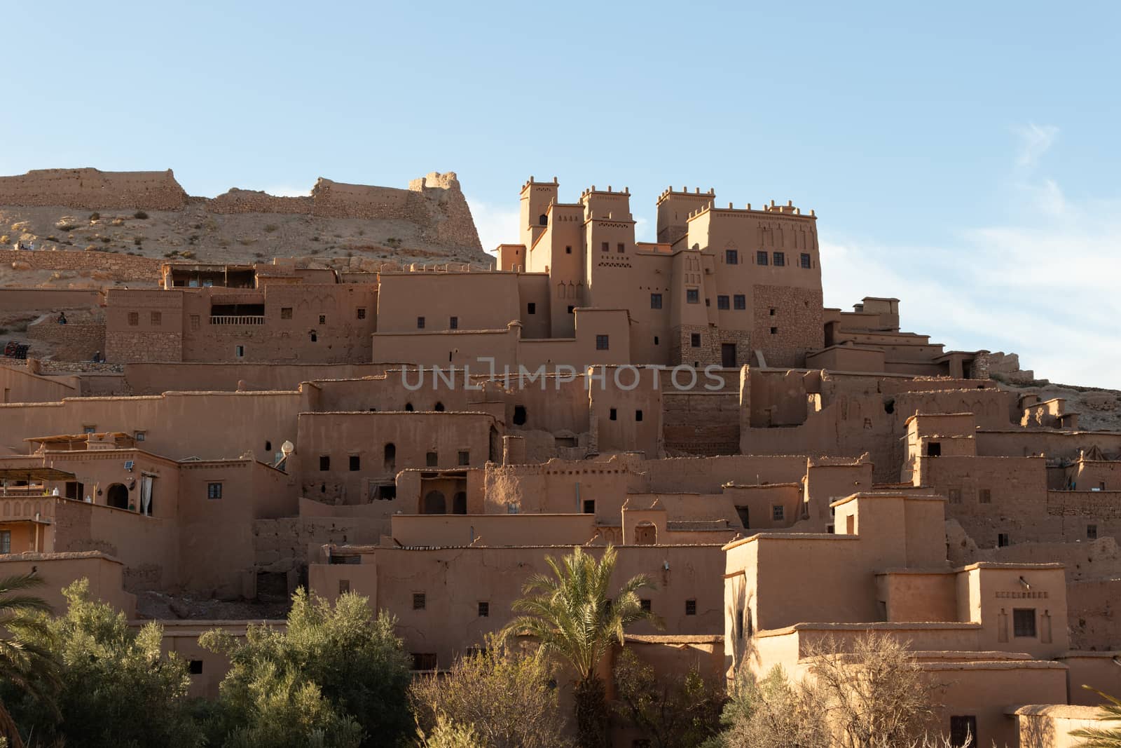 Ait Ben Haddou ksar Morocco, ancient fortress that is a Unesco Heritage site. Beautiful late afternoon light with honey, gold coloured mud brick construction the kasbah, or fortified town dates from 11th cent. and is on the former caravan route from the Sahara and Marrakech. The location has been used for many famous movies. High quality photo