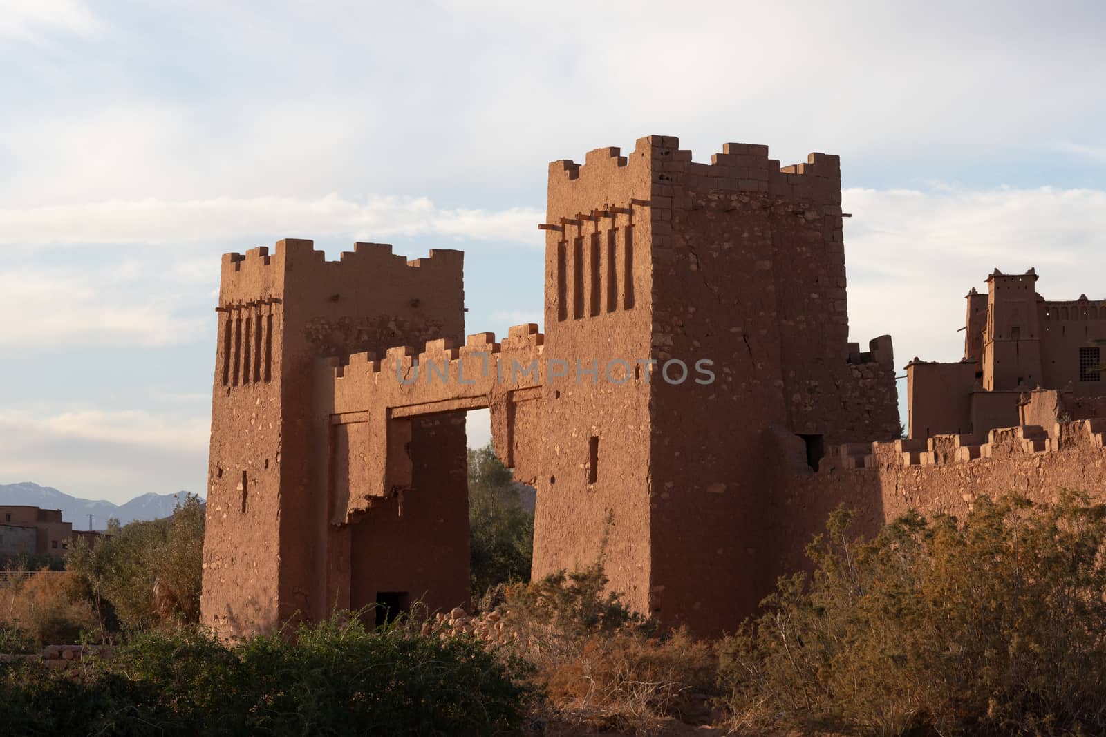 Ait Ben Haddou ksar Morocco, ancient fortress that is a Unesco Heritage site. Beautiful late afternoon light with honey, gold coloured mud brick construction the kasbah, or fortified town dates from 11th cent. and is on the former caravan route from the Sahara and Marrakech. The location has been used for many famous movies. High quality photo