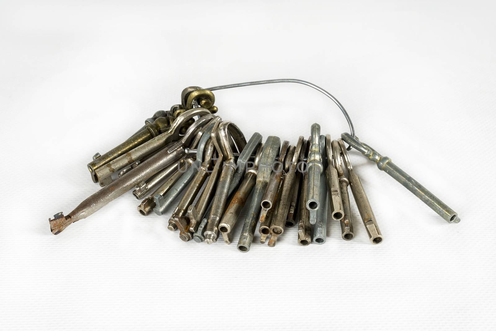 A set of old keys. Isolated over white background. View of many antique keys
