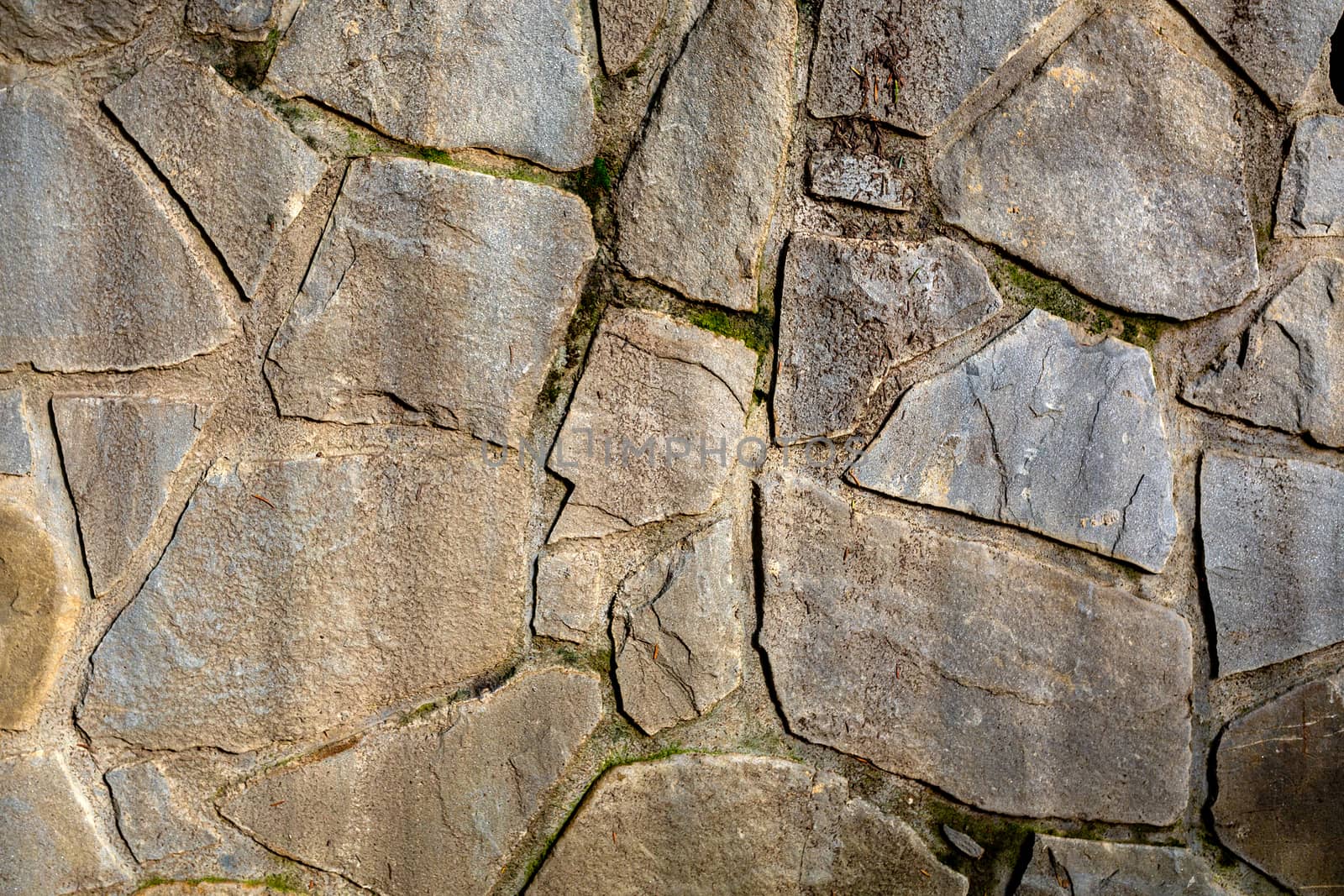 Background wall of stones. The surface of the stones is brown. Background texture