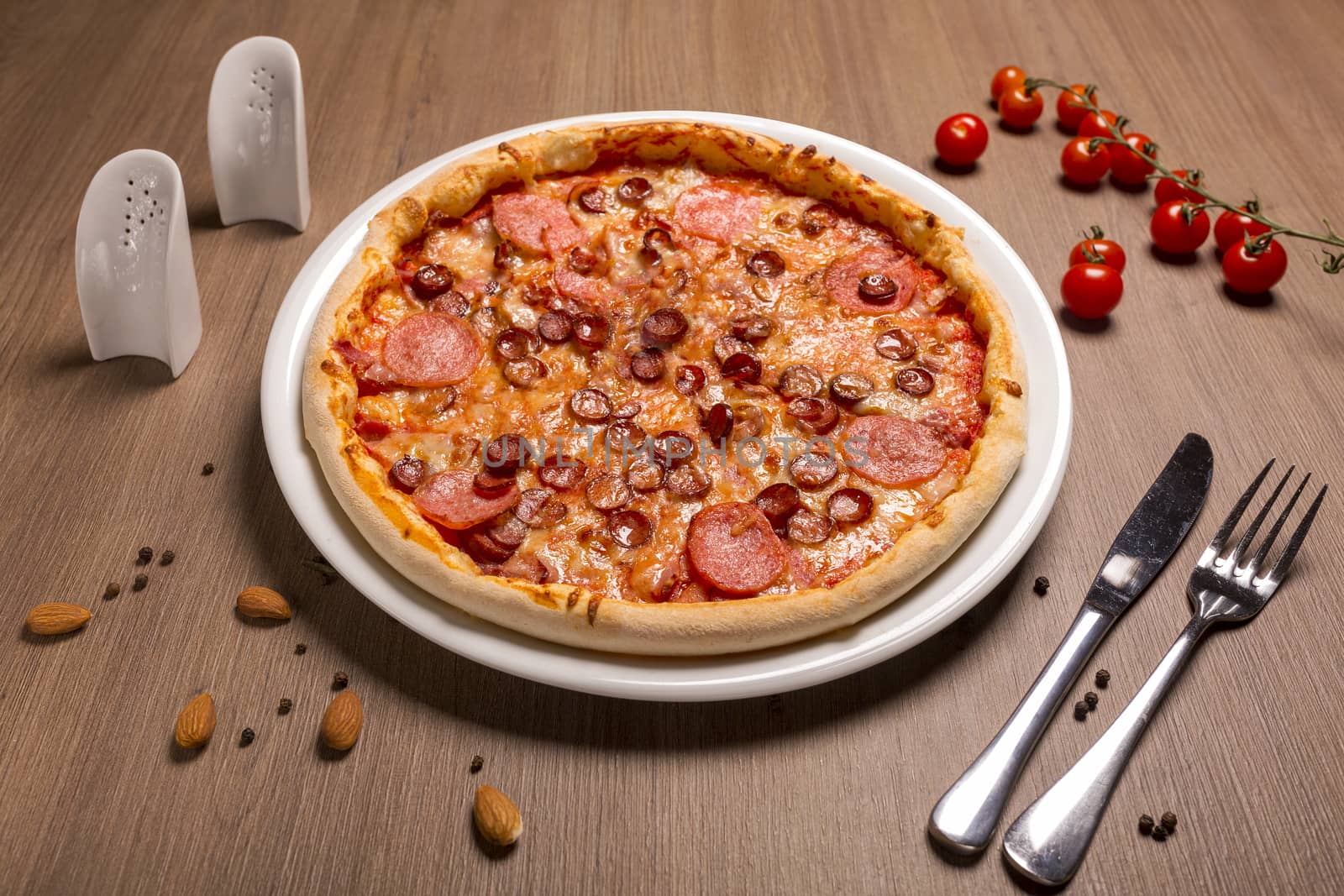 Pizza is super meat thin cake, tomato sauce, beef balyk, ham, bacon, hunting sausages Italian salami, mozzarella, basil.