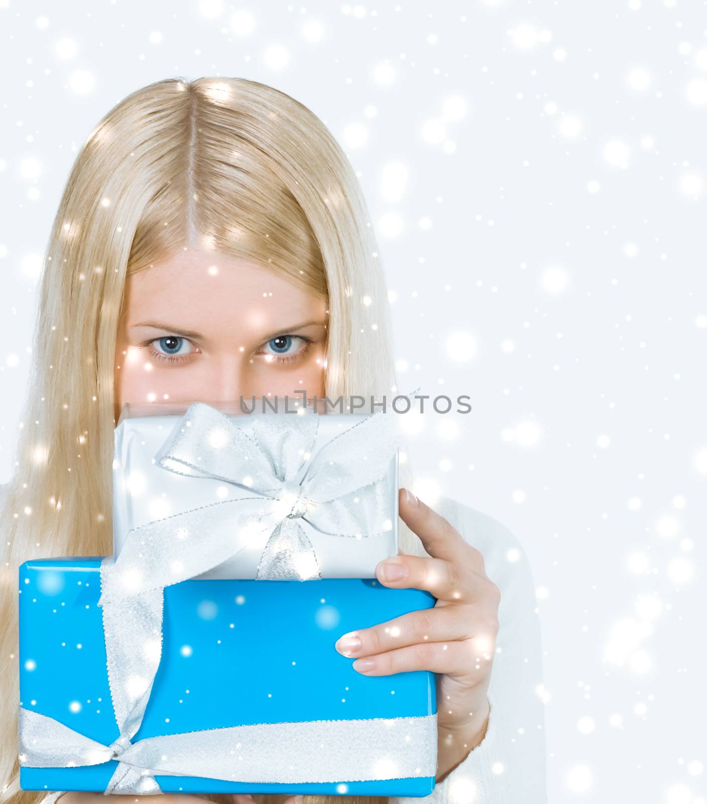 Magical Christmas and glitter snow background, happy blonde model with gift boxes in winter season for shopping sale and holiday brands