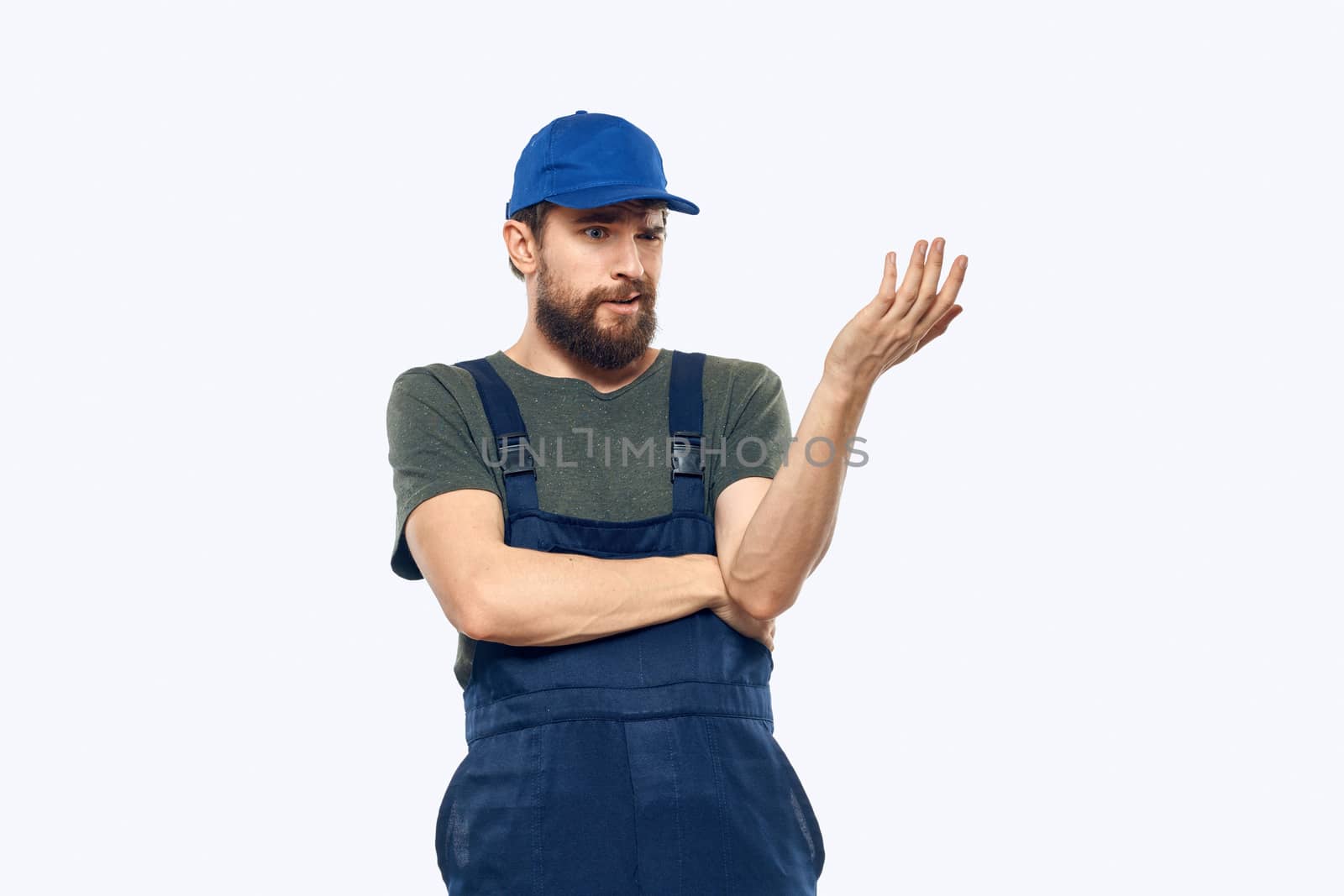 Worker man uniform delivery service emotions studio light background. High quality photo