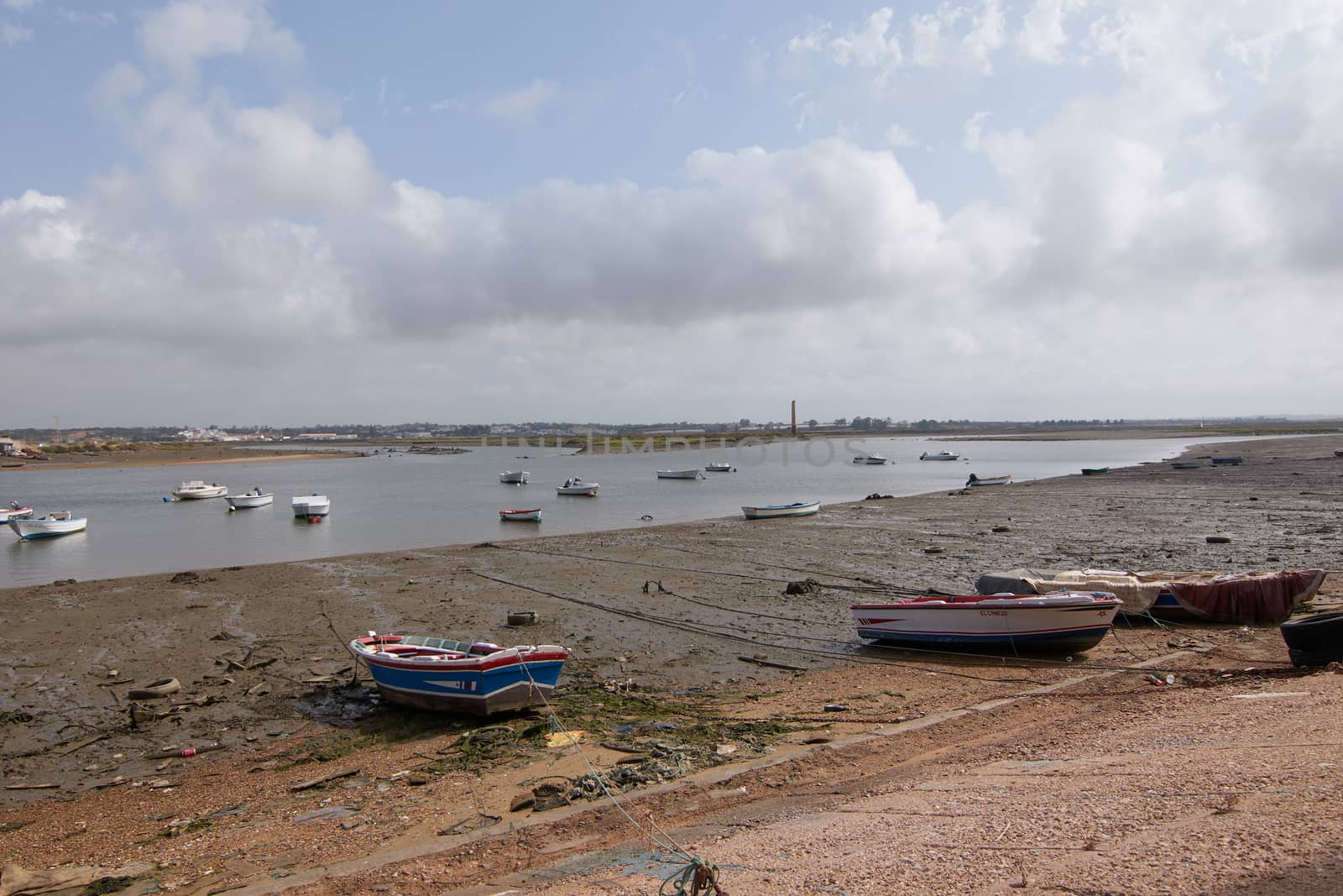 Fishing bay with boats at sea and in the mud and crabs walking in the sand