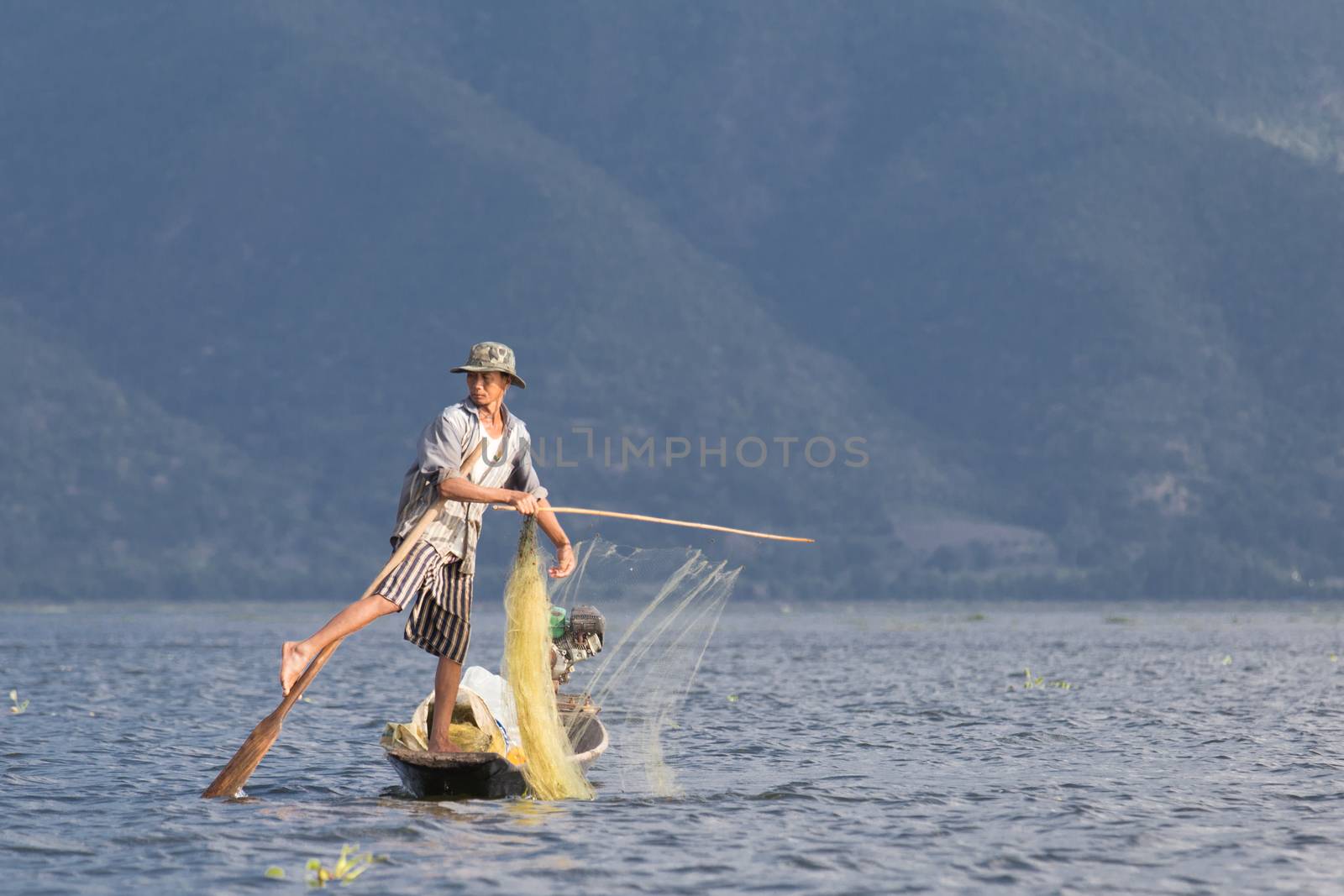 Inle Lake, Myanmar 12/16/2015 traditional Intha fisherman rowing with one leg by kgboxford